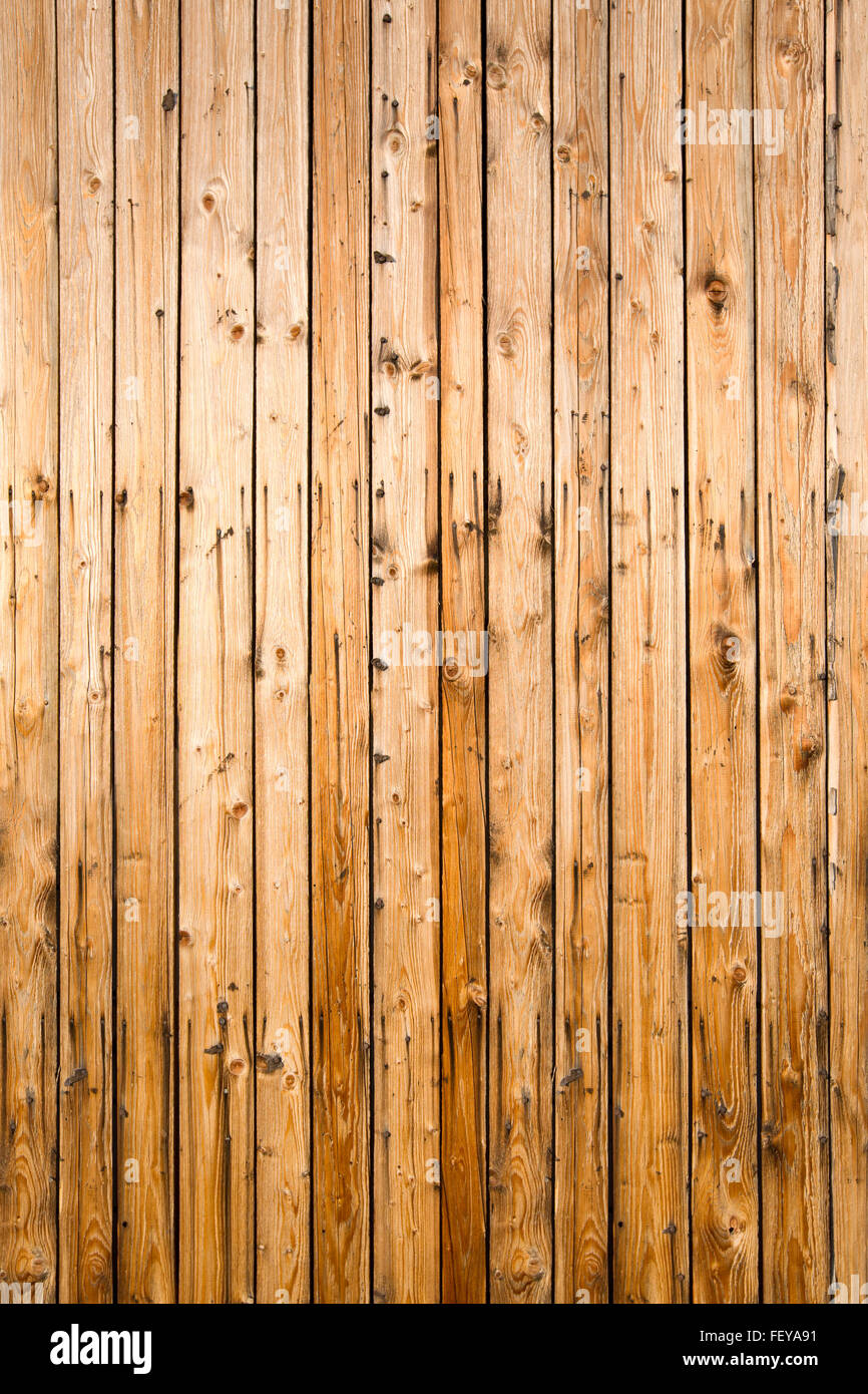 Weathered yellow fence from natural wood, portrait Stock Photo
