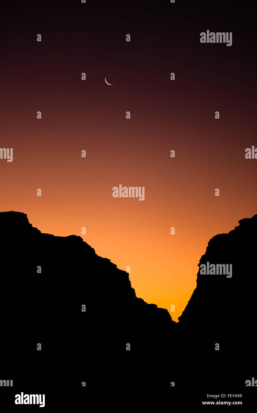 The Sun will soon replace the Moon in the Wadi Rum desert, Jordan. Stock Photo