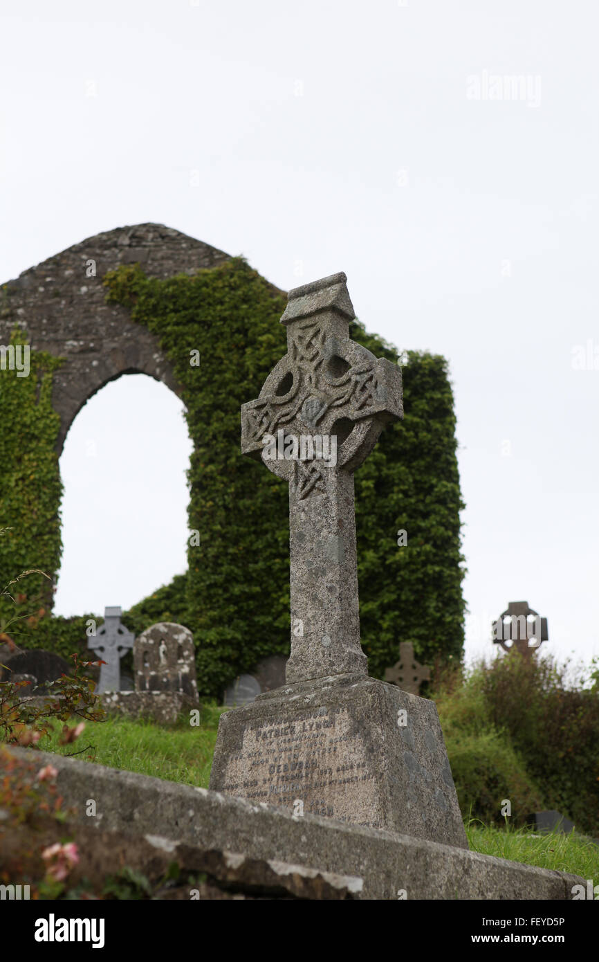 High cross in a ruin graveyard in rural Ireland Stock Photo