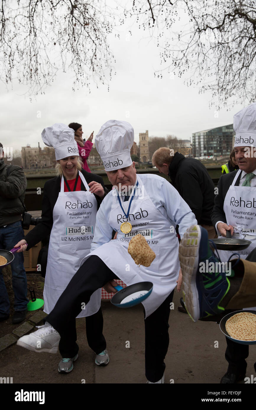 Westminster, London, UK. 9th February 2016. Stephen Pound MP for Ealing North tosses a pancake  undr his leg at the Rehab Parliamentary Pancake Race 2016 Credit:  Keith Larby/Alamy Live News Stock Photo