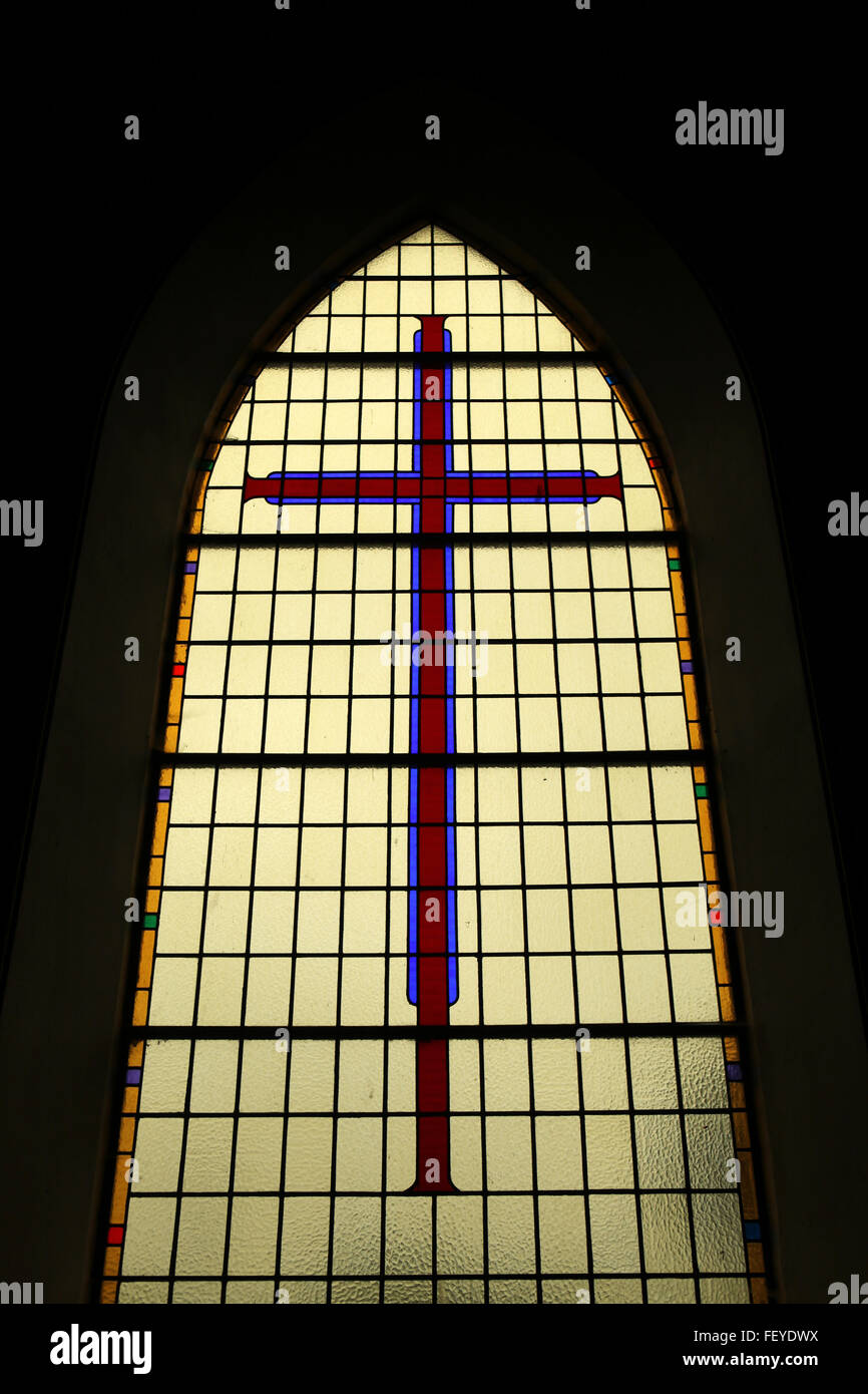 Atmospheric Dark And Beautiful Stain Glass Church Window With A Cross atmospheric-dark-and-beautiful-stain-glass-church-window-with-a-cross