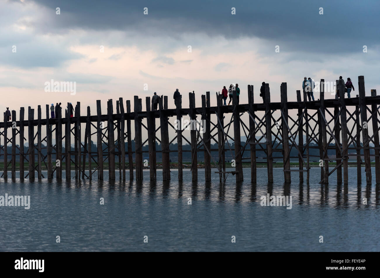 People walk the U Bein Bridge across the Taungthaman Lake in Amarapura ...