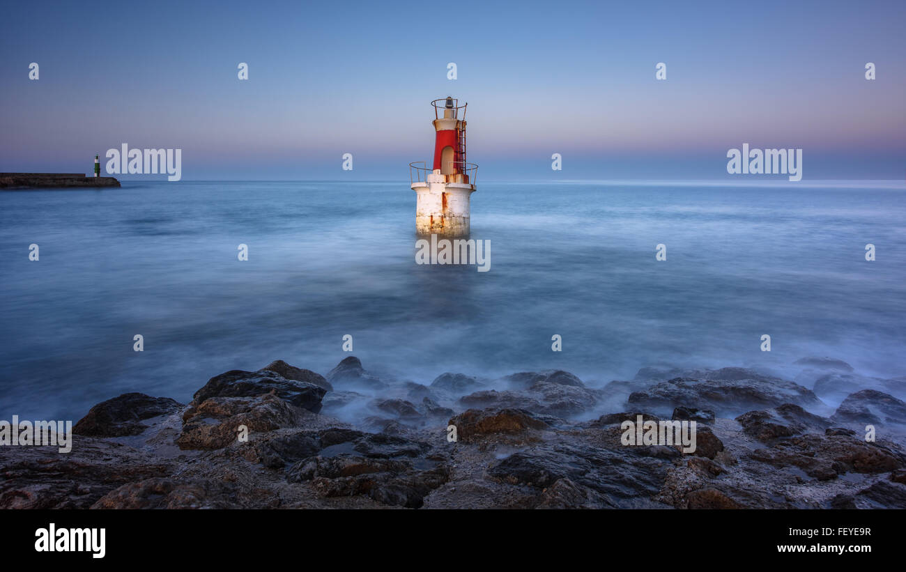 A small lighthouse by dusk, San Vicente de la Barquera, Cantabria, Spain. Stock Photo