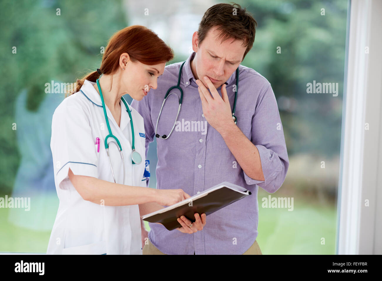 Doctor and nurse discussing notes Stock Photo