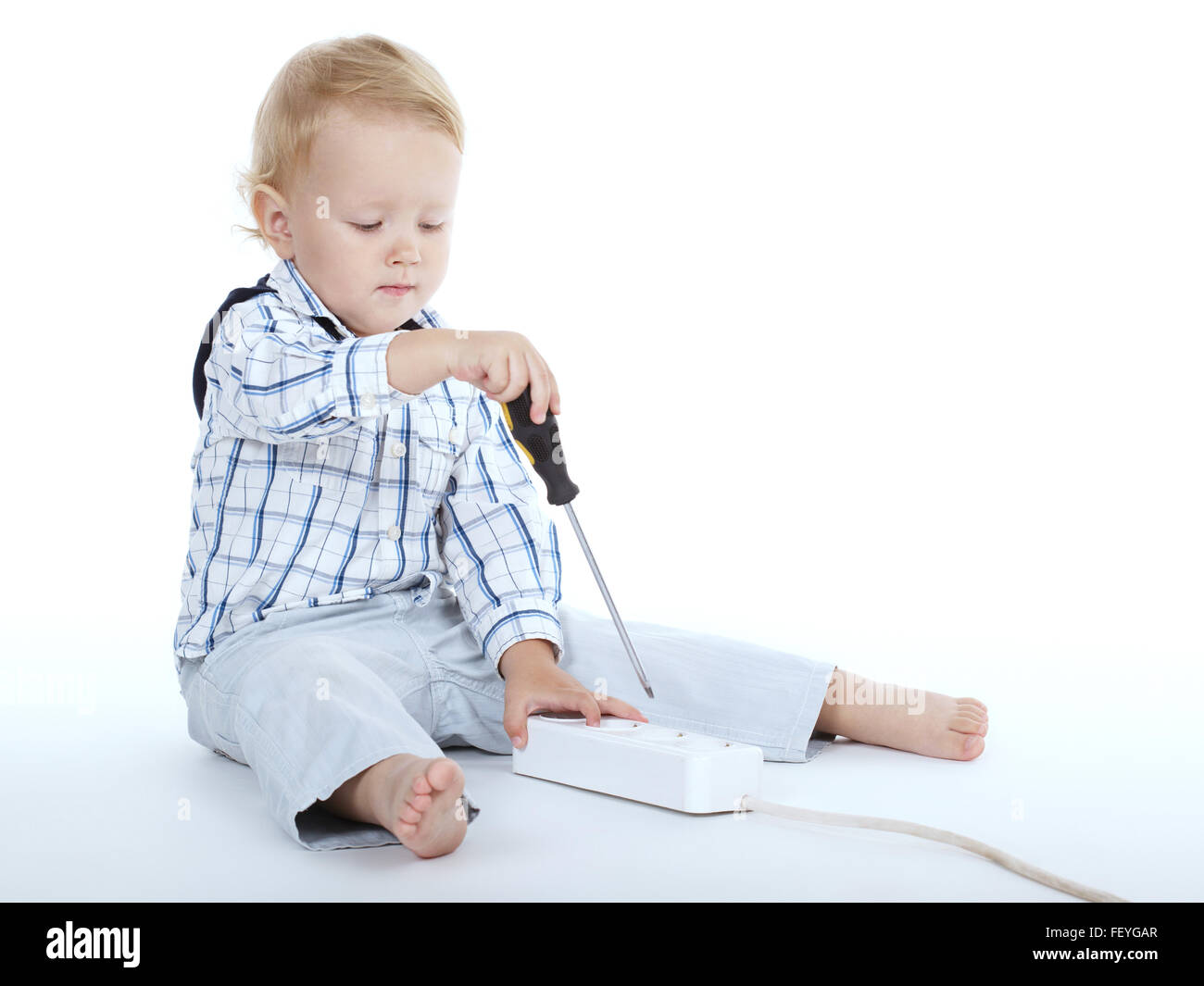 boy plays with plug and screwdriver Stock Photo Alamy
