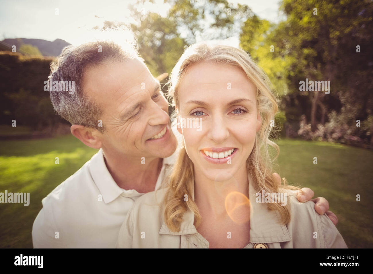 Husband whispering something to wifes ears Stock Photo