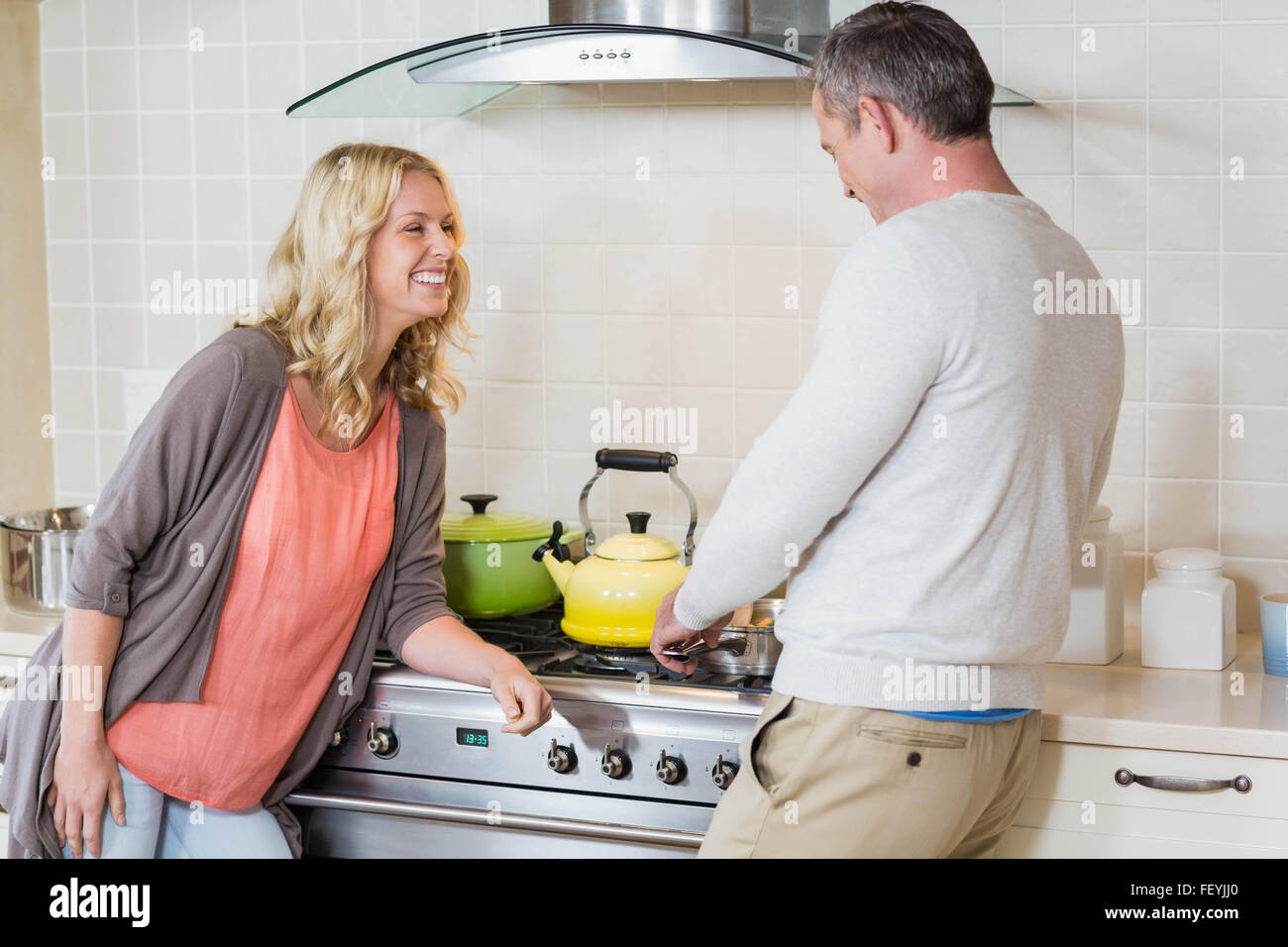 Cute couple using copper kettle Stock Photo