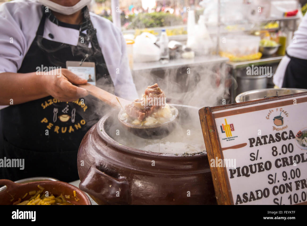 Chef cooking 'Patasca'.  Peruvian seasoning and flavor, food fair. La Limeñita boulevard, Camana Street, historical Center; Lima Stock Photo