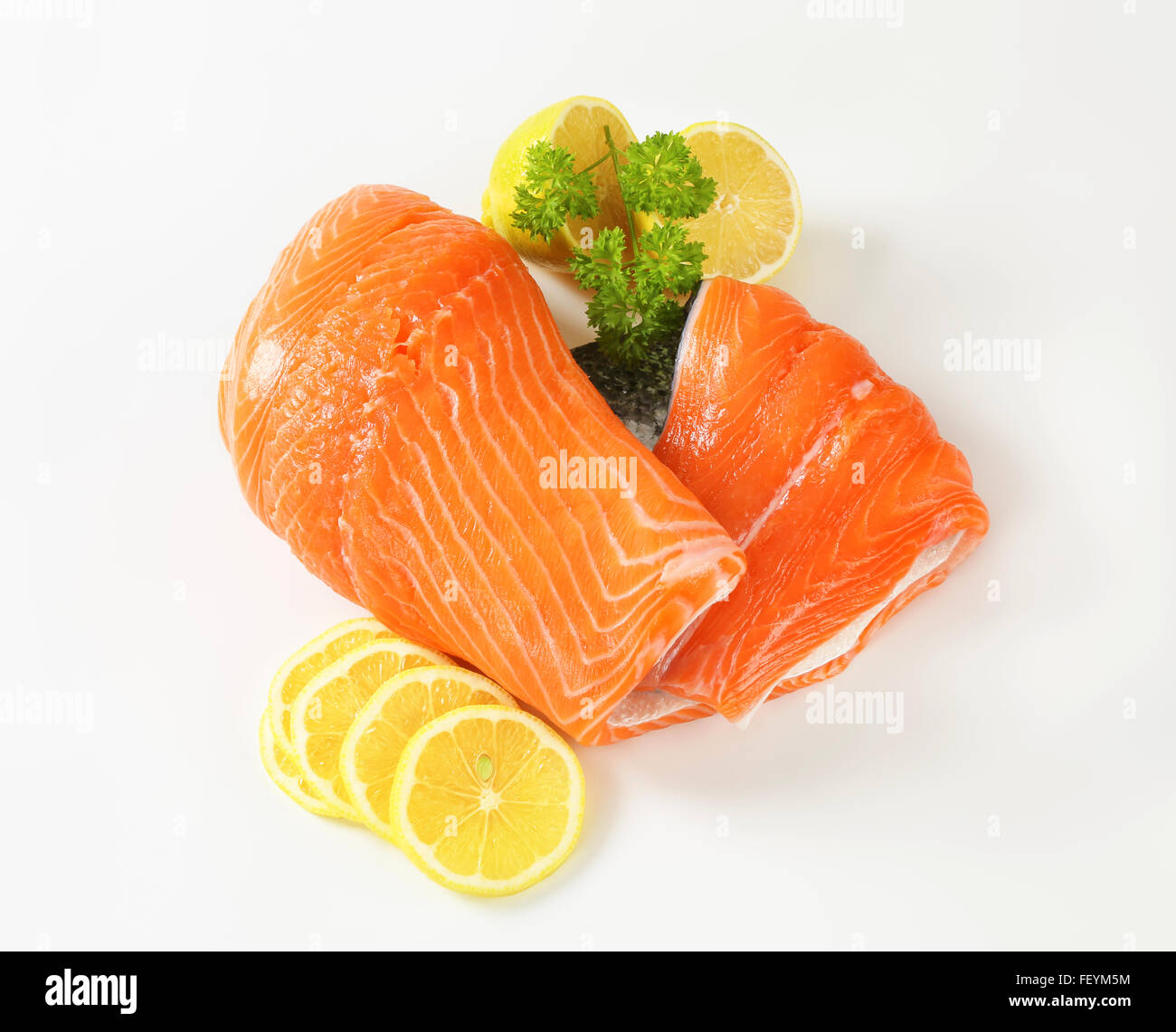 raw salmon fillet and lemon slices on white background Stock Photo - Alamy