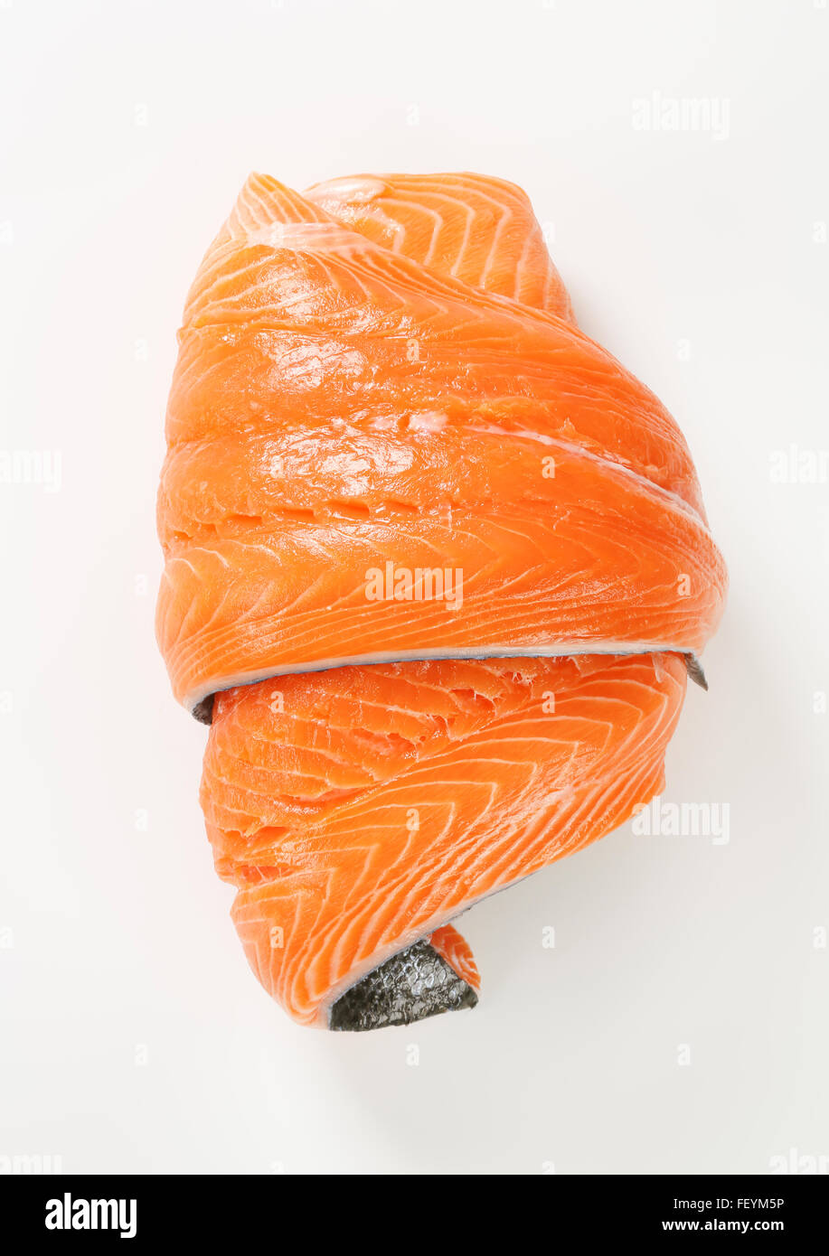 roll of raw salmon fillet on white background Stock Photo - Alamy