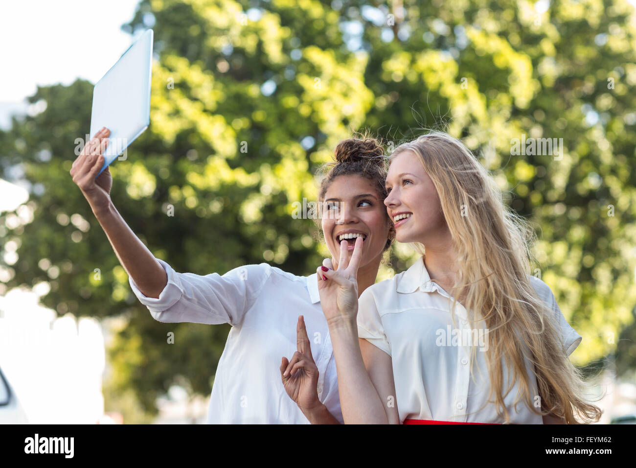 Hip friends taking selfies with tablet Stock Photo