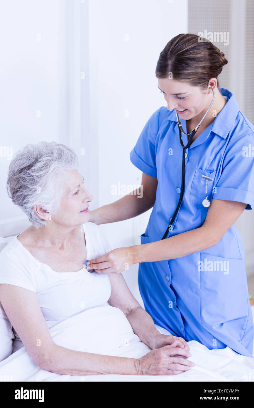 Doctor taking care of suffering senior patient Stock Photo Alamy