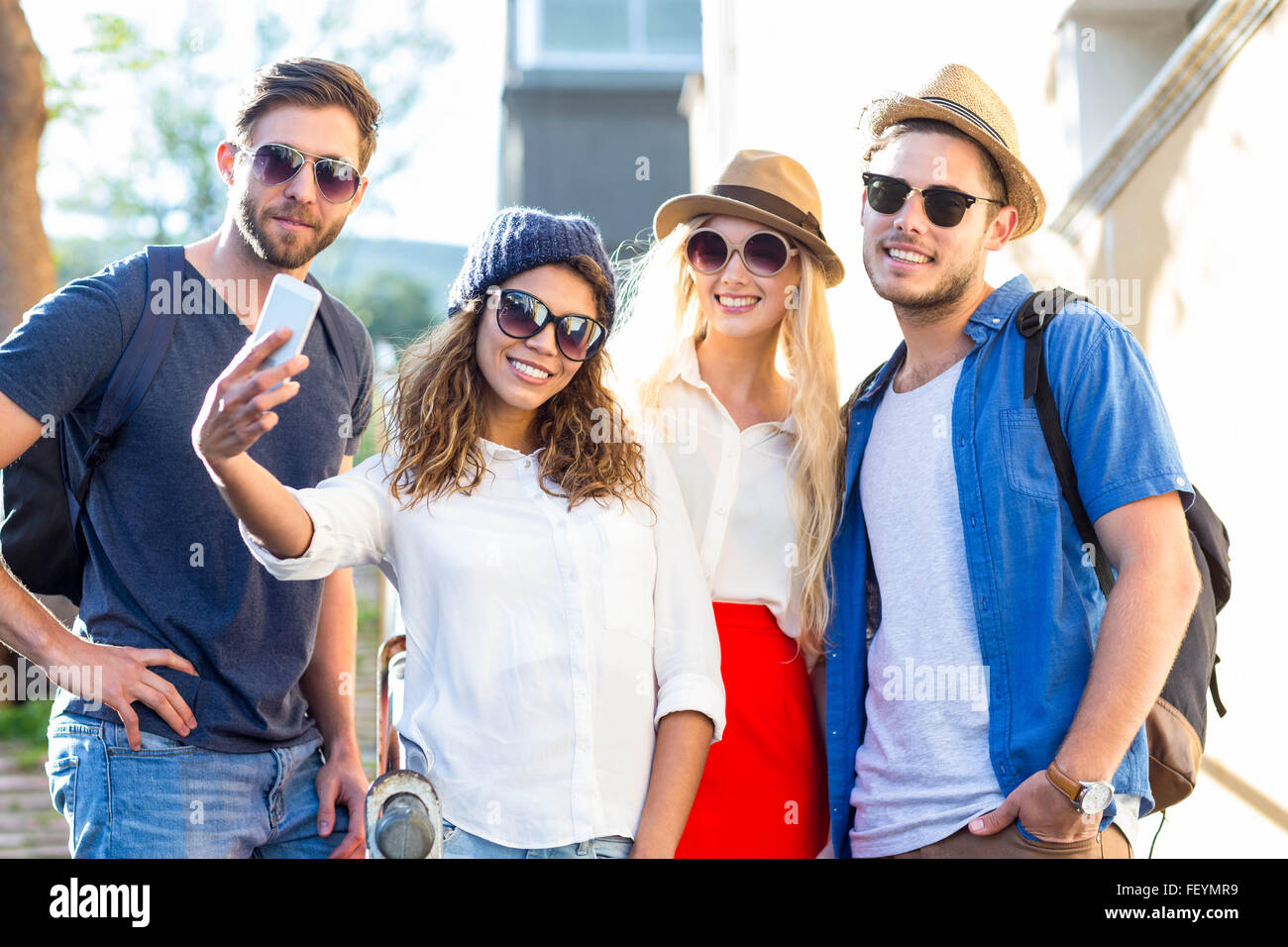 Hip friends taking selfies Stock Photo