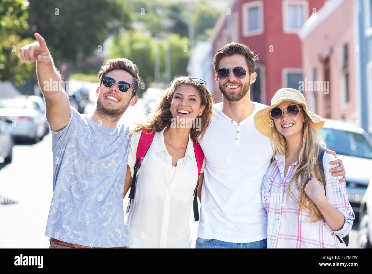 Hip friends pointing somewhere Stock Photo