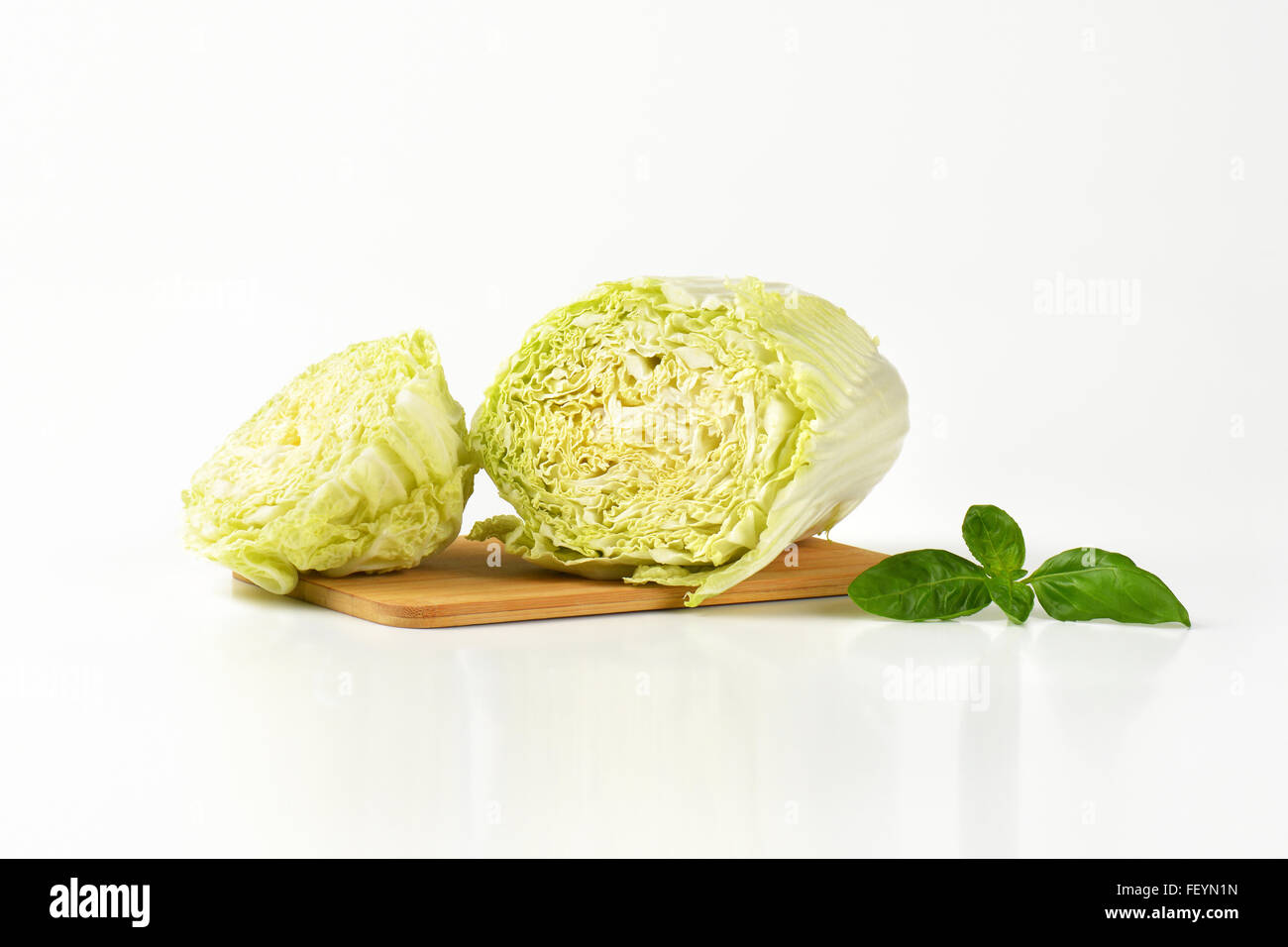 halved chinese cabbage on wooden cutting board Stock Photo