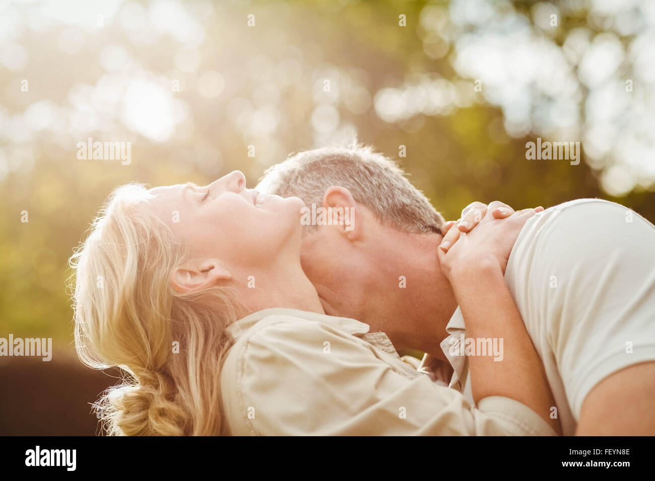 Husband kissing wife on the neck Stock Photo