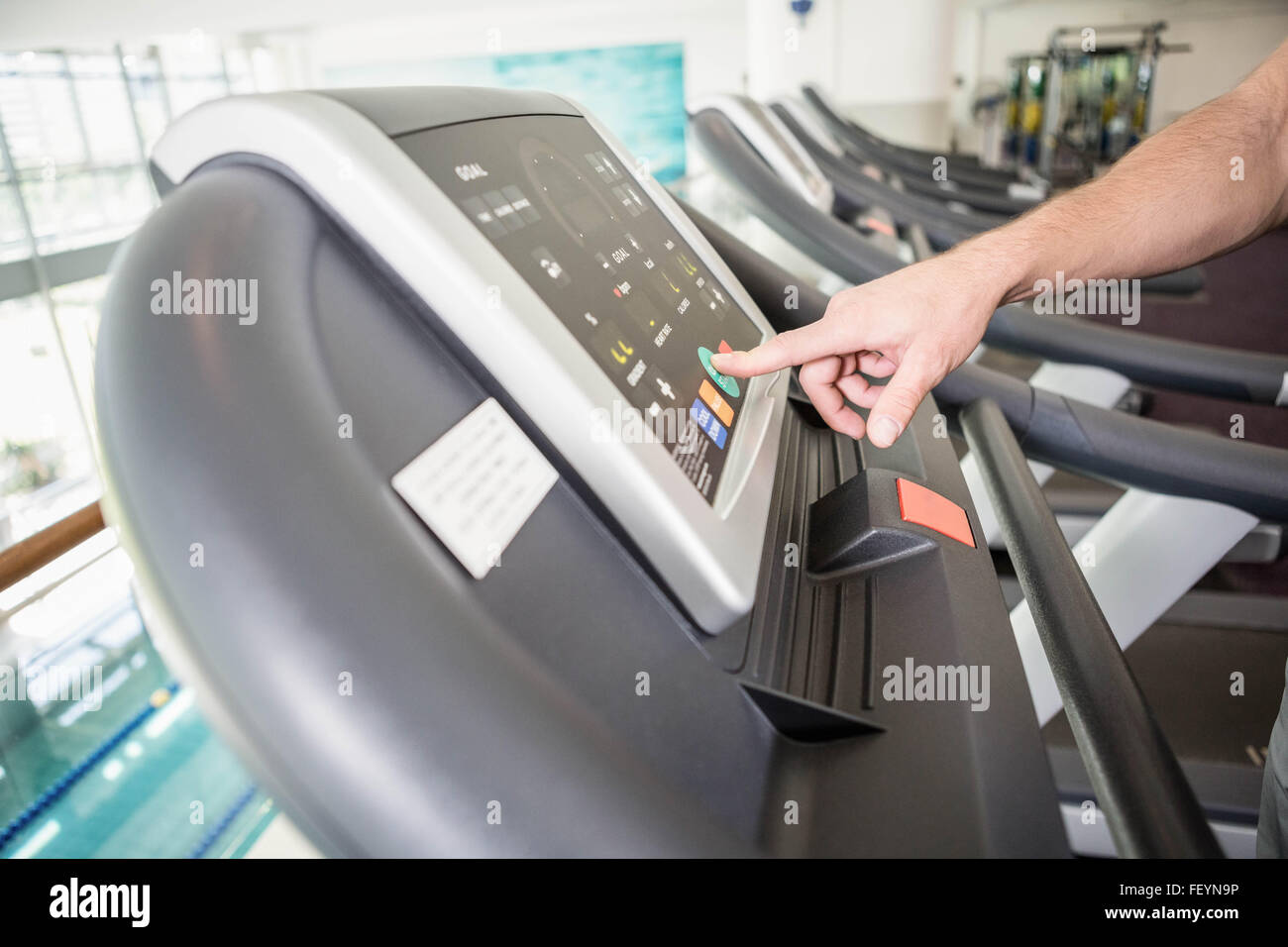 mans hand setting treadmill Stock Photo