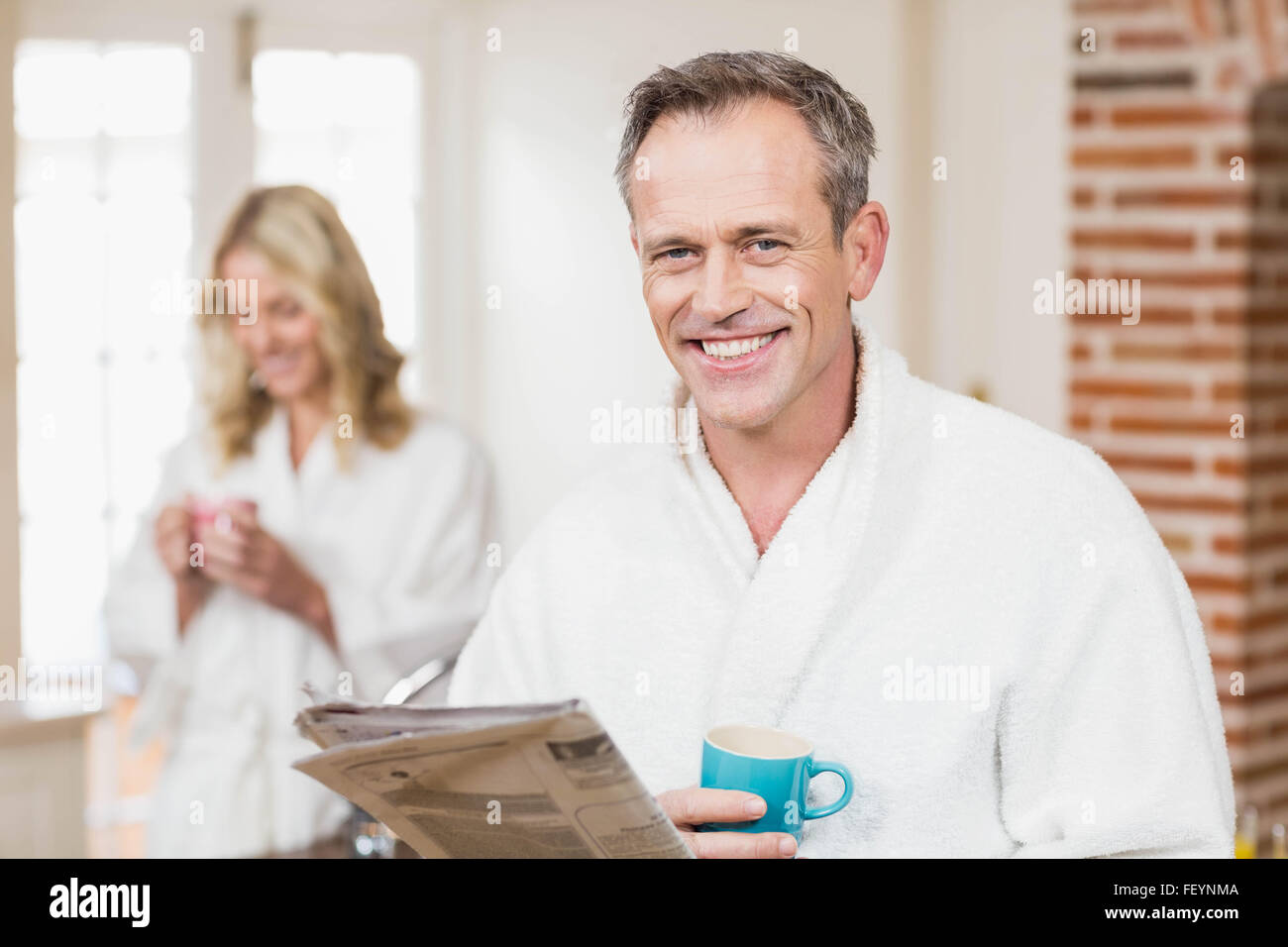 Cute couple having coffee and reading news Stock Photo