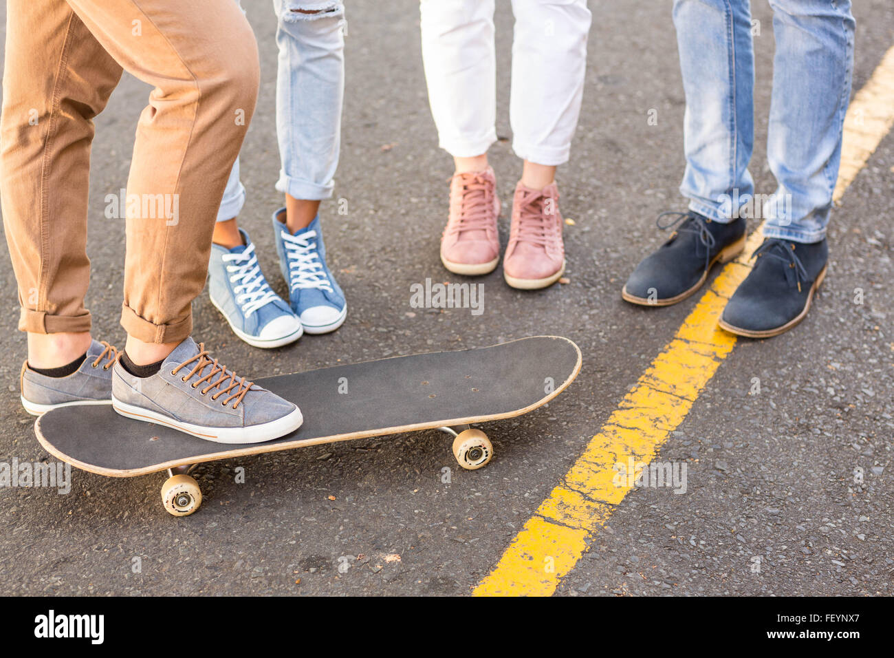 Lower section of hip friends and skateboard Stock Photo