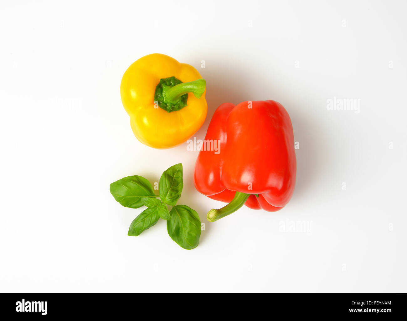 yellow and red bell peppers on white background Stock Photo - Alamy