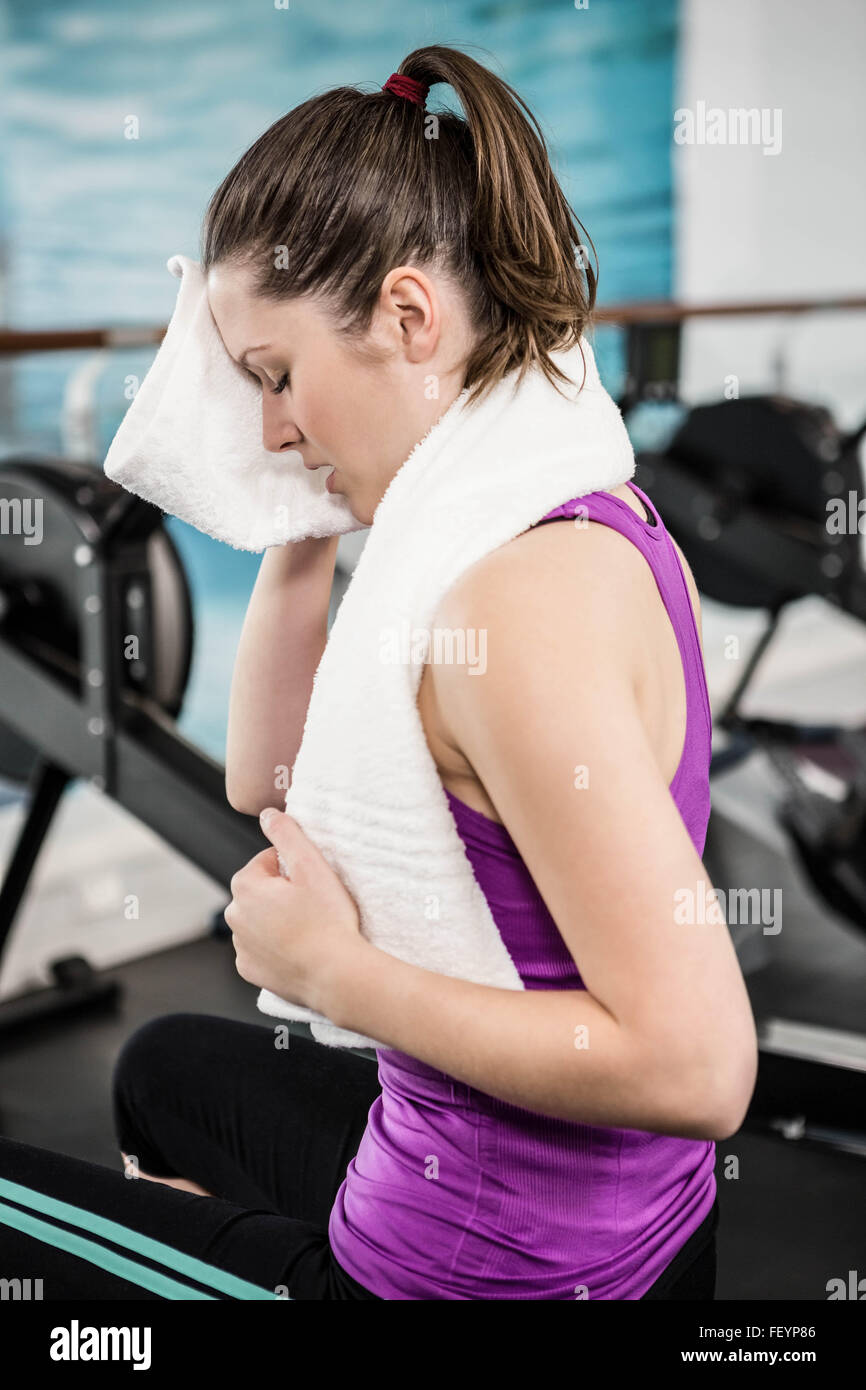 Fit brunette wiping sweat with towel Stock Photo