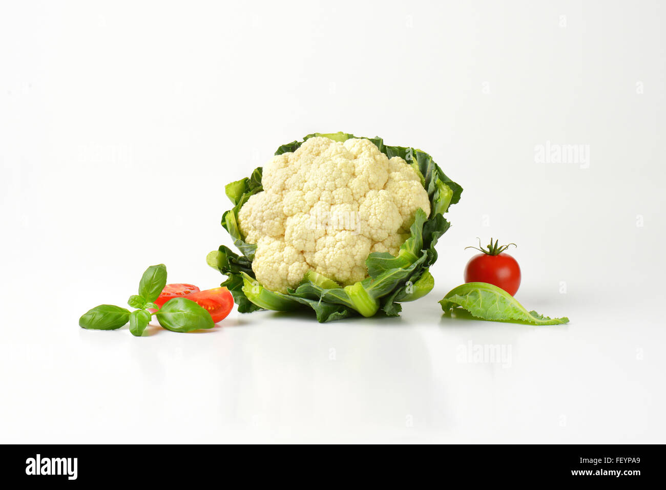 head of fresh cauliflower and tomatoes on white background Stock Photo