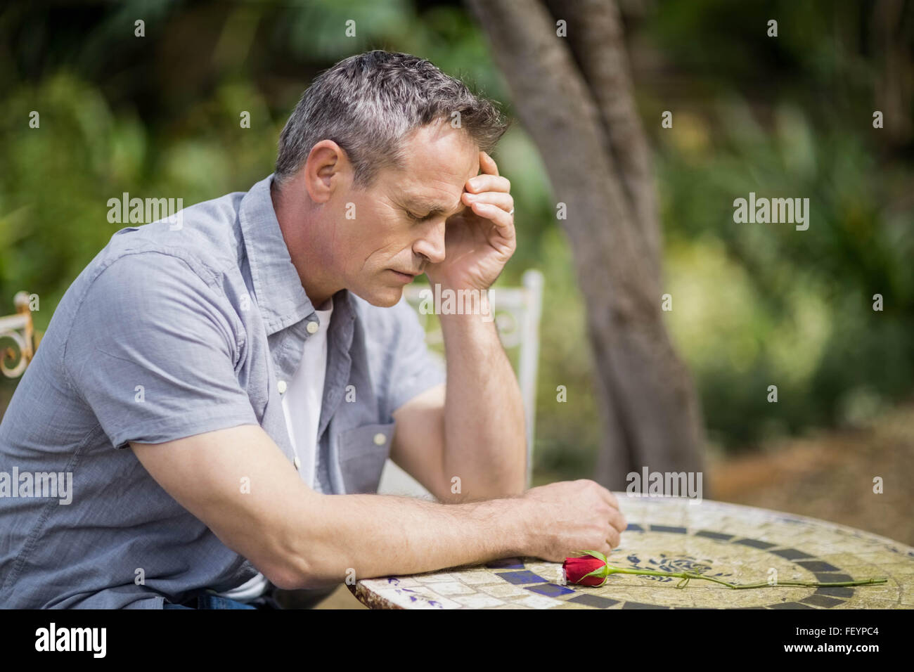 Depressed man touching his forehead Stock Photo