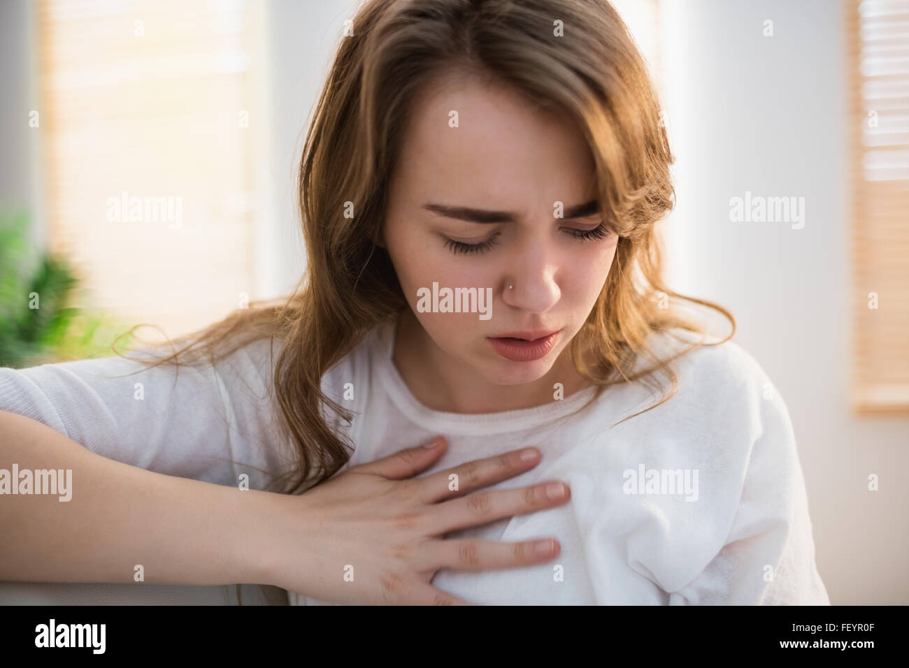 Pretty woman suffering from chest pain Stock Photo
