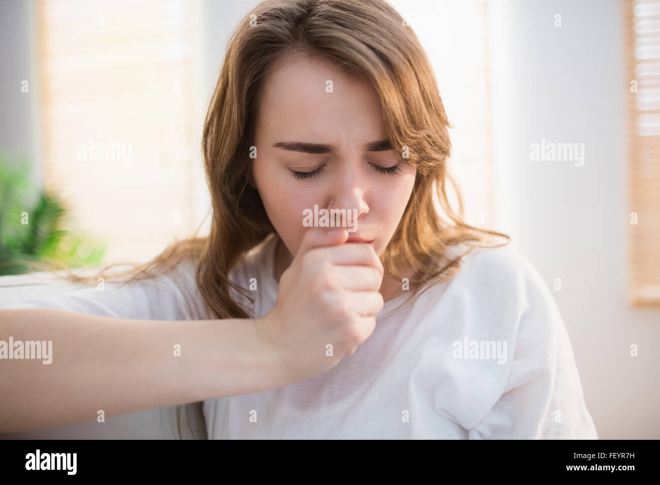 Pretty woman coughing Stock Photo