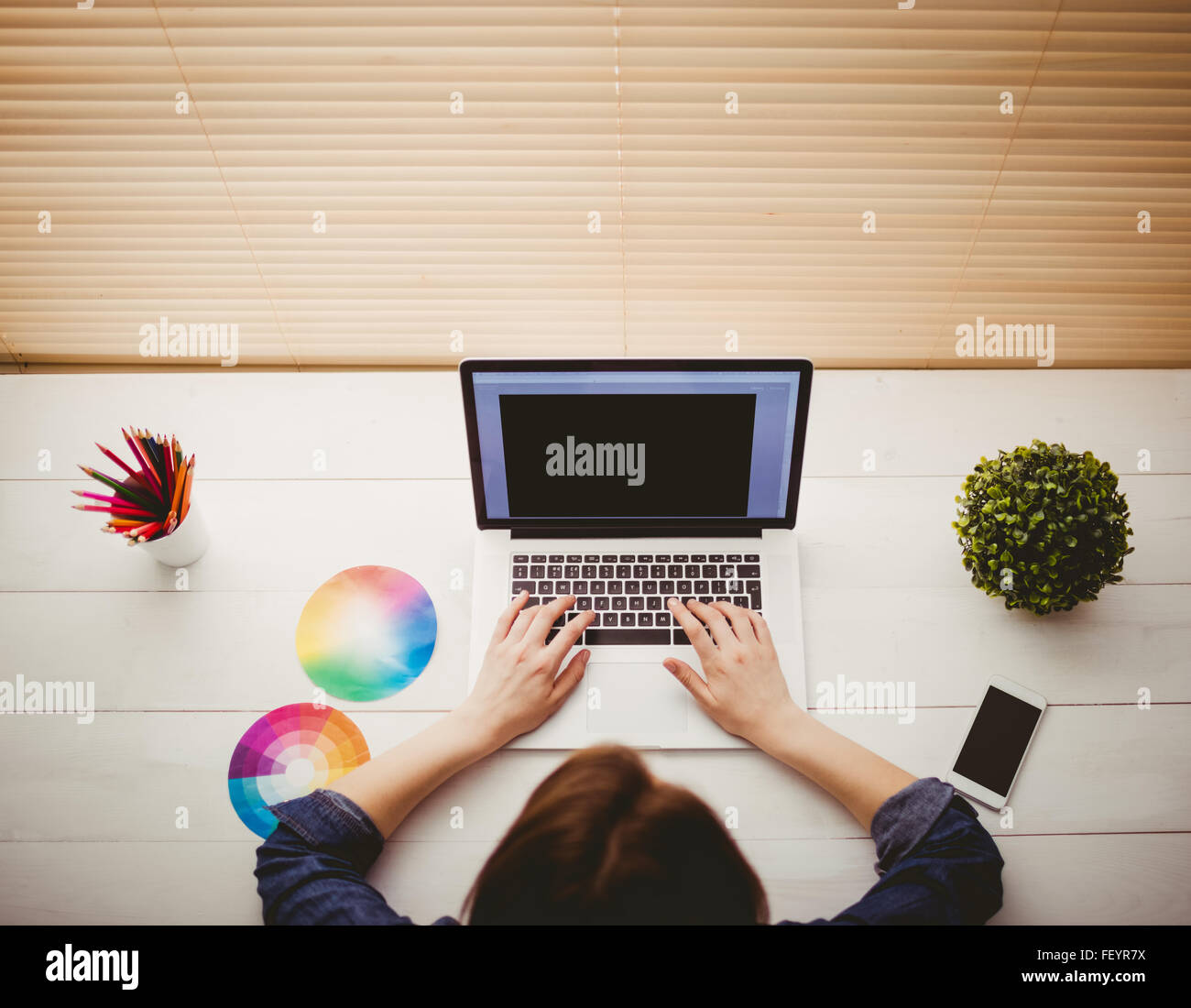 Overhead view of businesswoman using laptop Stock Photo