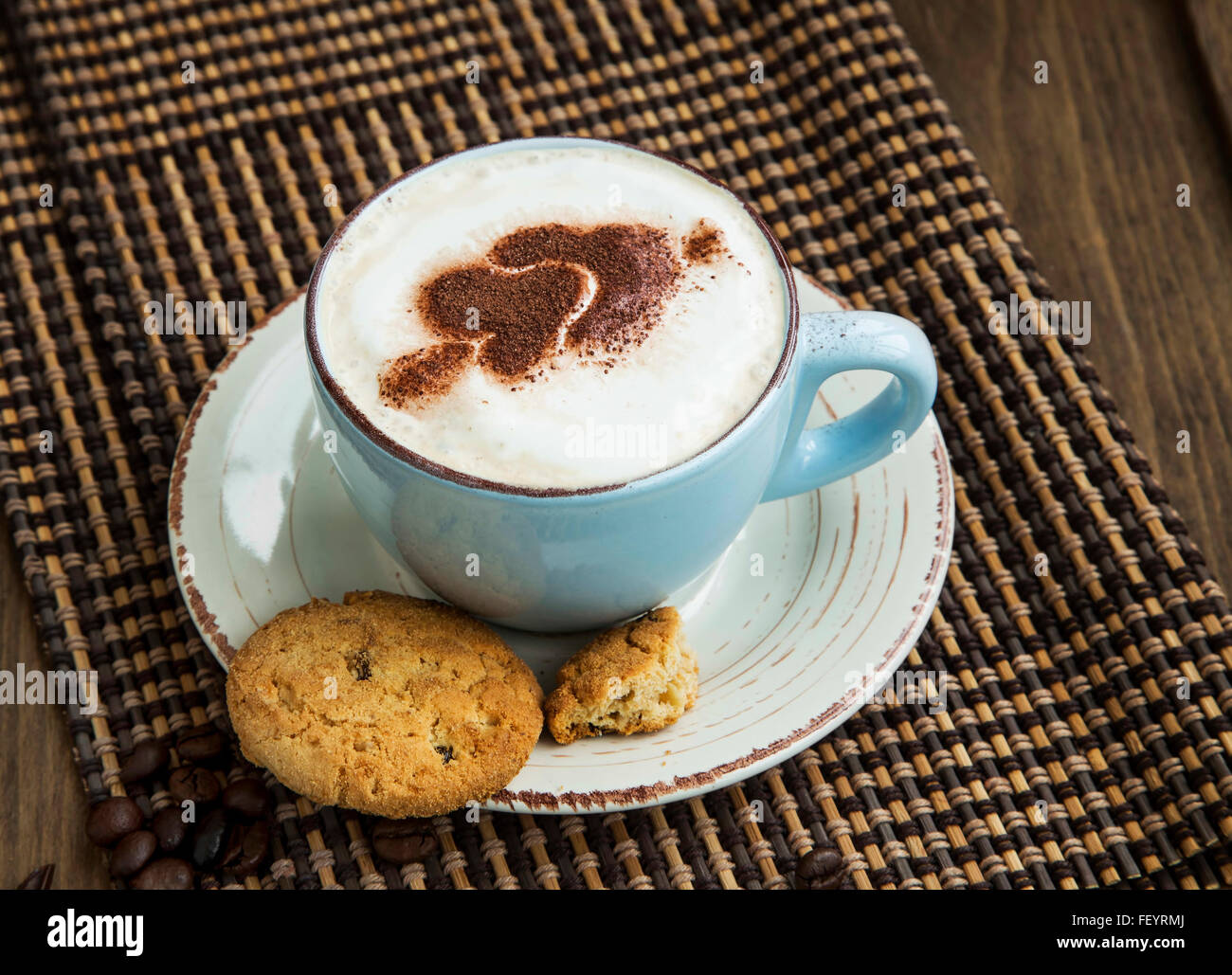 Cappuccino coffee with froth and cocoa heart shape and cookies Stock Photo