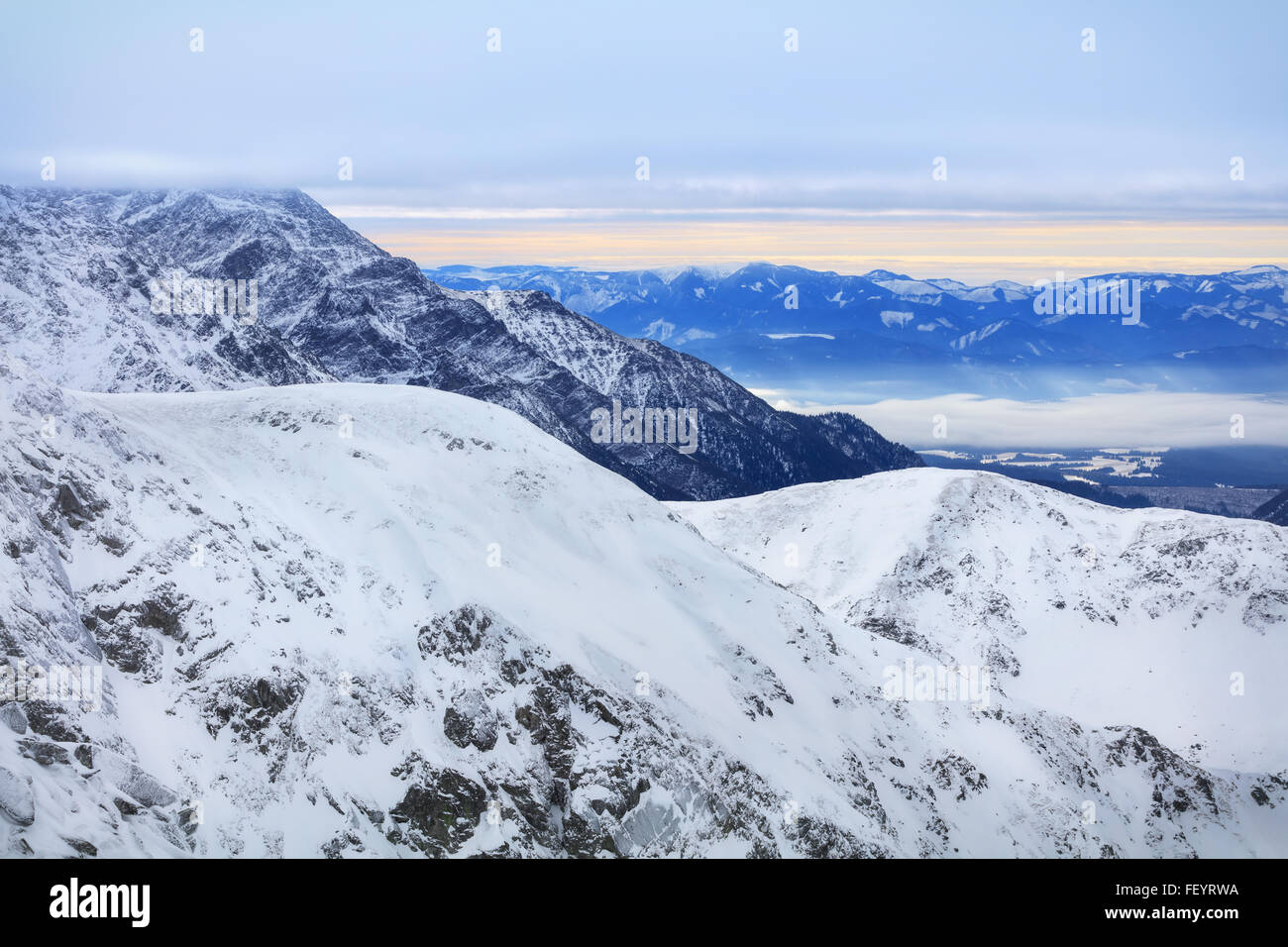 Winter landscape of high snowy mountains Stock Photo