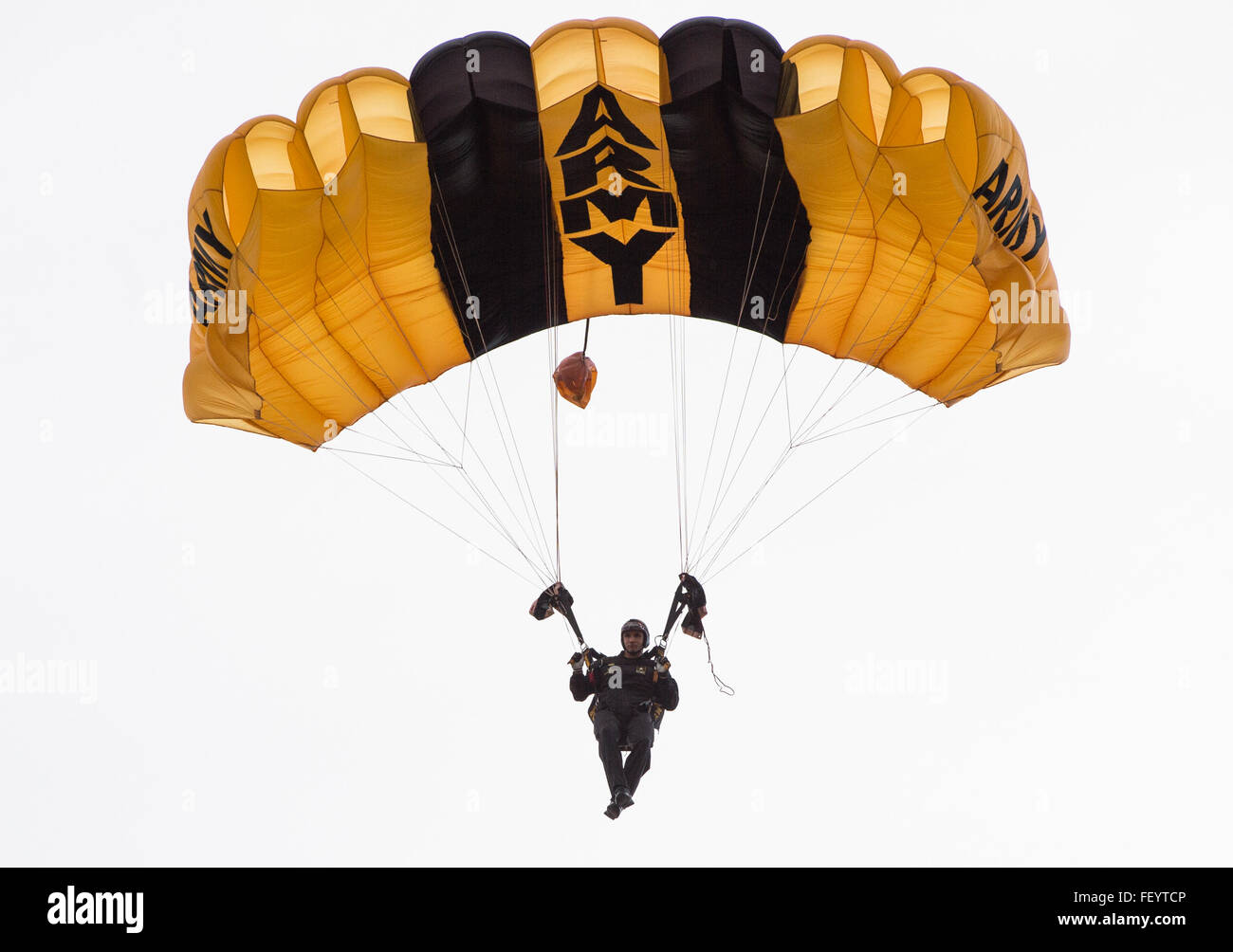 A U.S. Army Special Operations Forces parachute team member descends toward Luzon Drop Zone during the 18th Annual Randy Oler Memorial Operation Toy Drop, hosted by U.S. Army Civil Affairs & Psychological Operations Command (Airborne) at Camp Mackall, N.C., Dec. 7, 2015. Operation Toy Drop is the world's largest combined airborne operation and provides soldiers the opportunity to help children in need receive toys for the holidays. Stock Photo