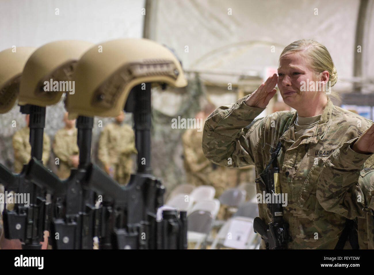Service members from several units at Bagram Air Field, Afghanistan, pay their respects during a fallen comrade ceremony held in honor of six Airmen Dec. 23, 2015. The six Airmen lost their lives in an improvised explosive attack near Bagram Dec. 21, 2015. Stock Photo