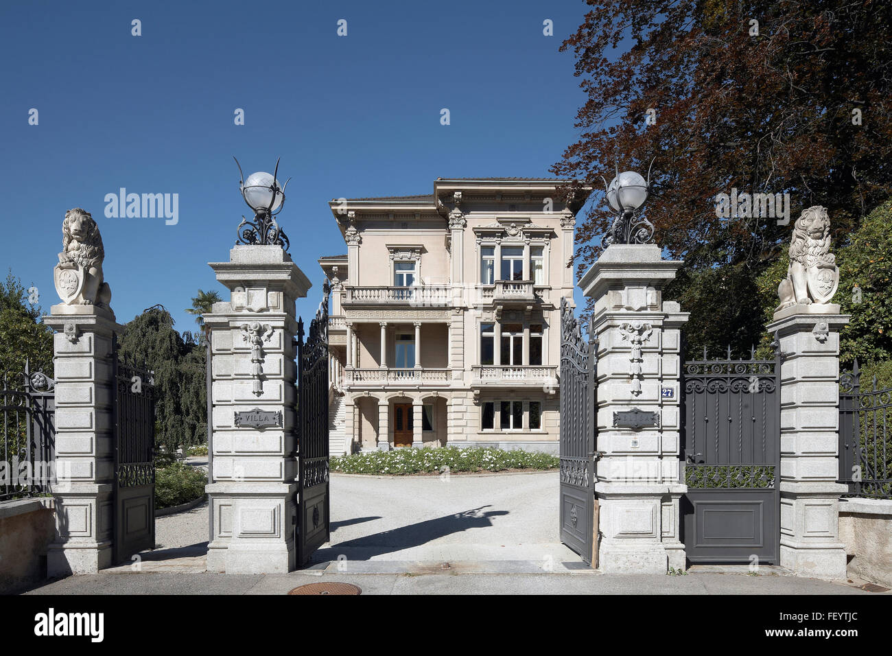 Luxury villa entrance iron gate with pillars with lions in Switzerland