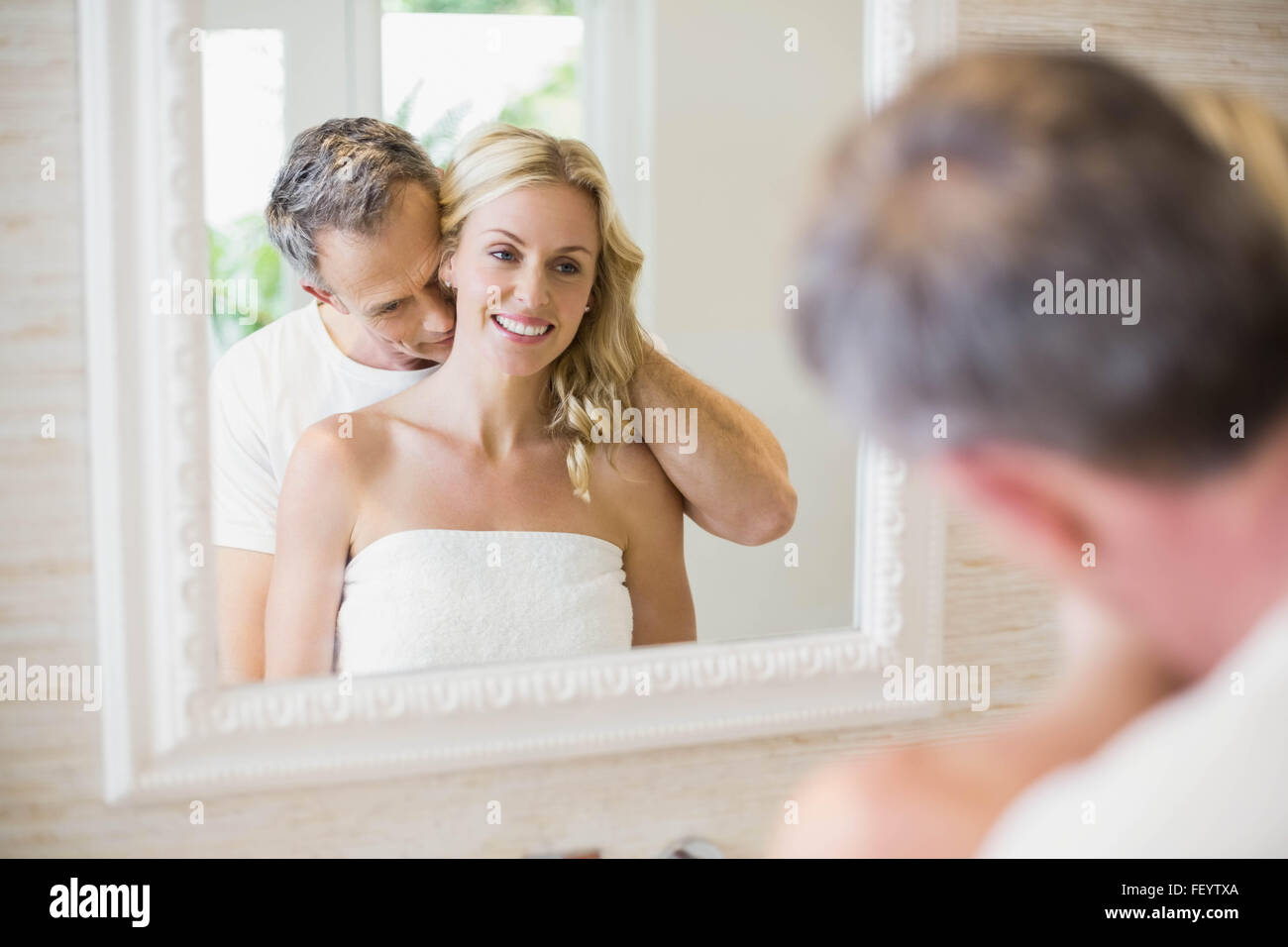 Husband kissing wife on the neck Stock Photo