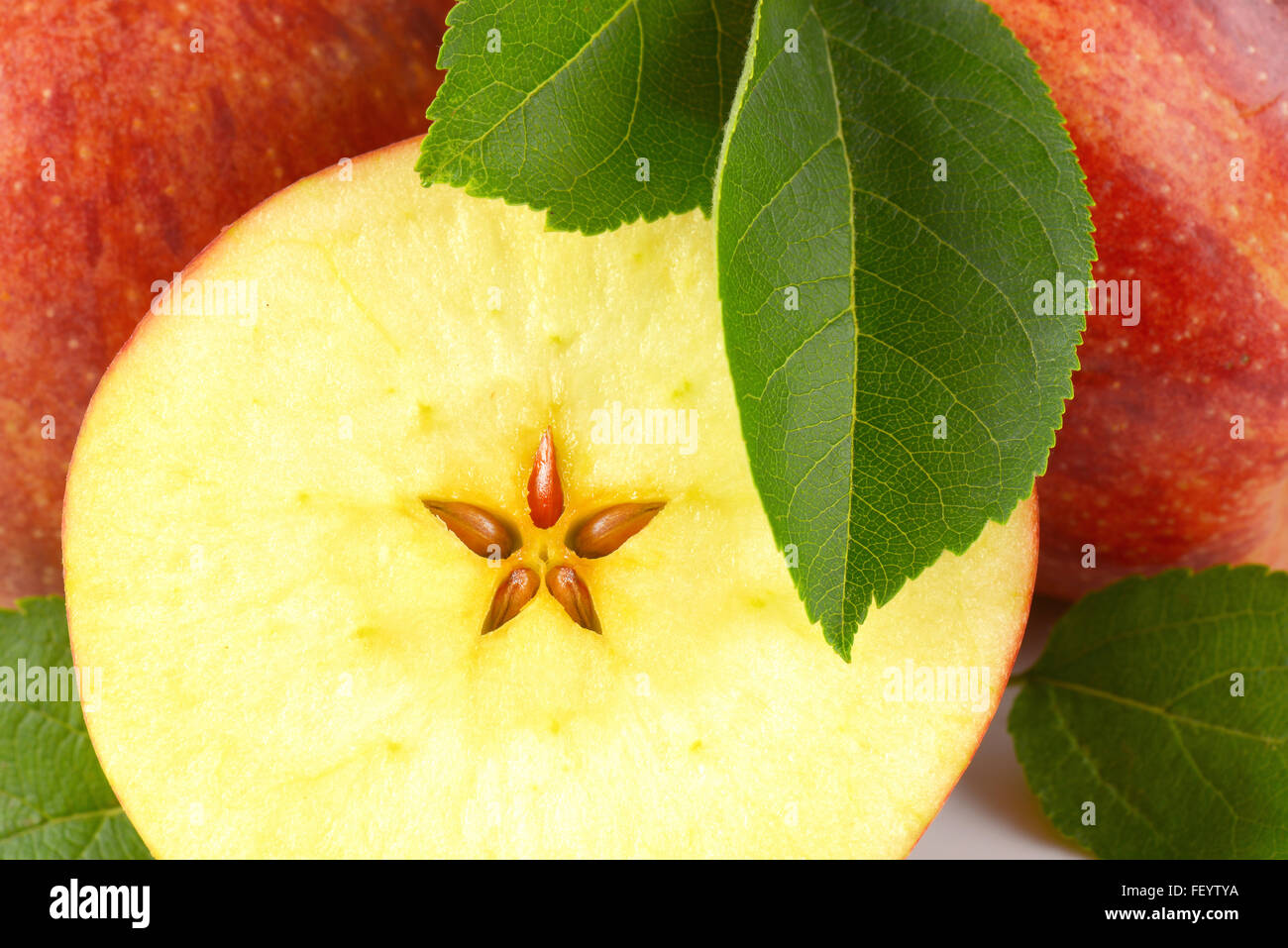 detail of half an apple with leaves Stock Photo
