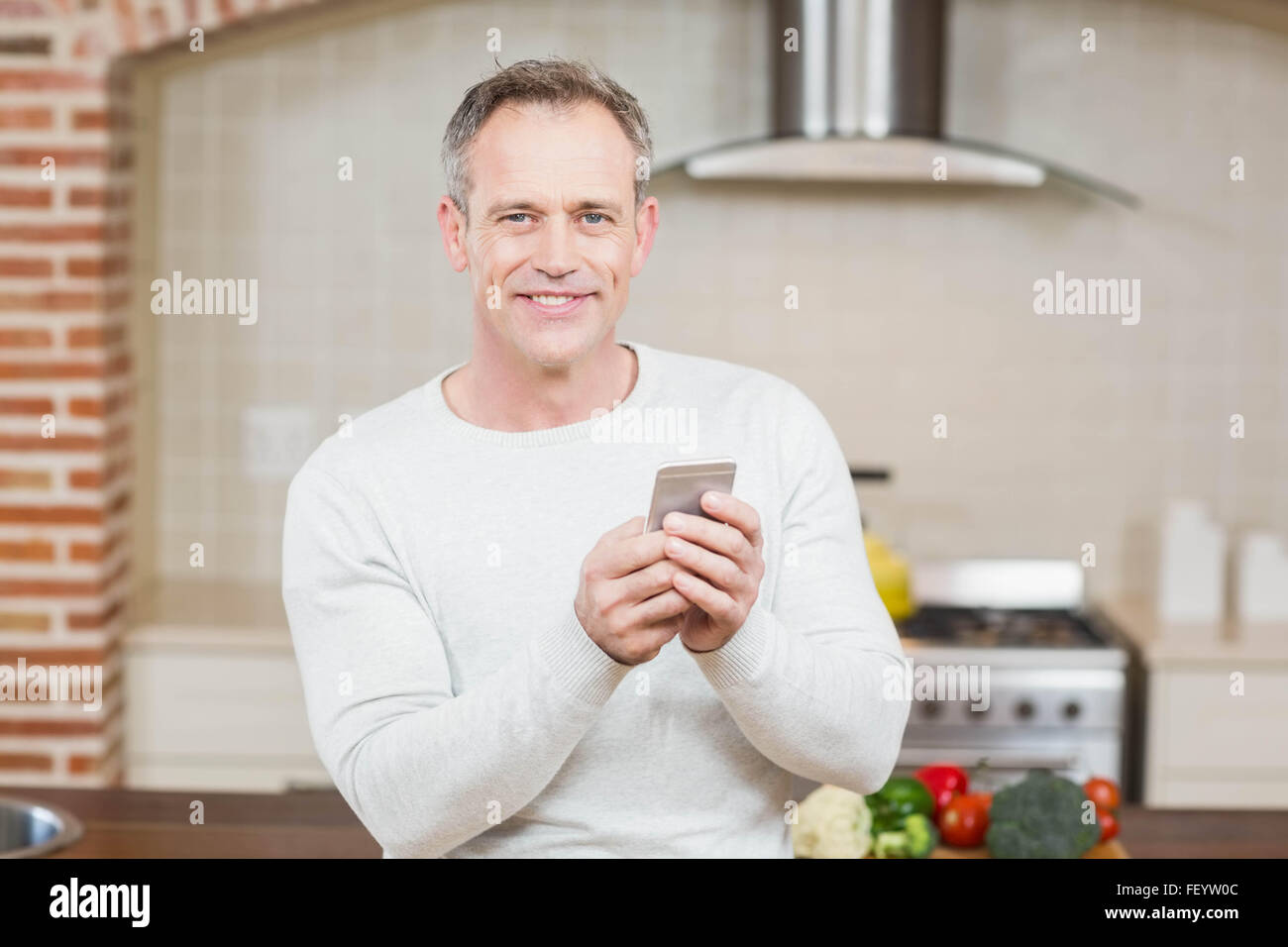 Handsome man looking at smartphone Stock Photo