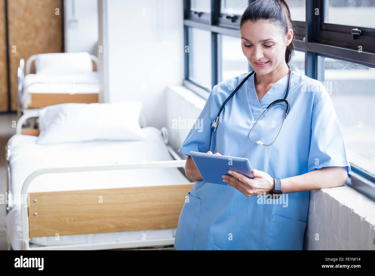 Nurse using her tablet pc Stock Photo