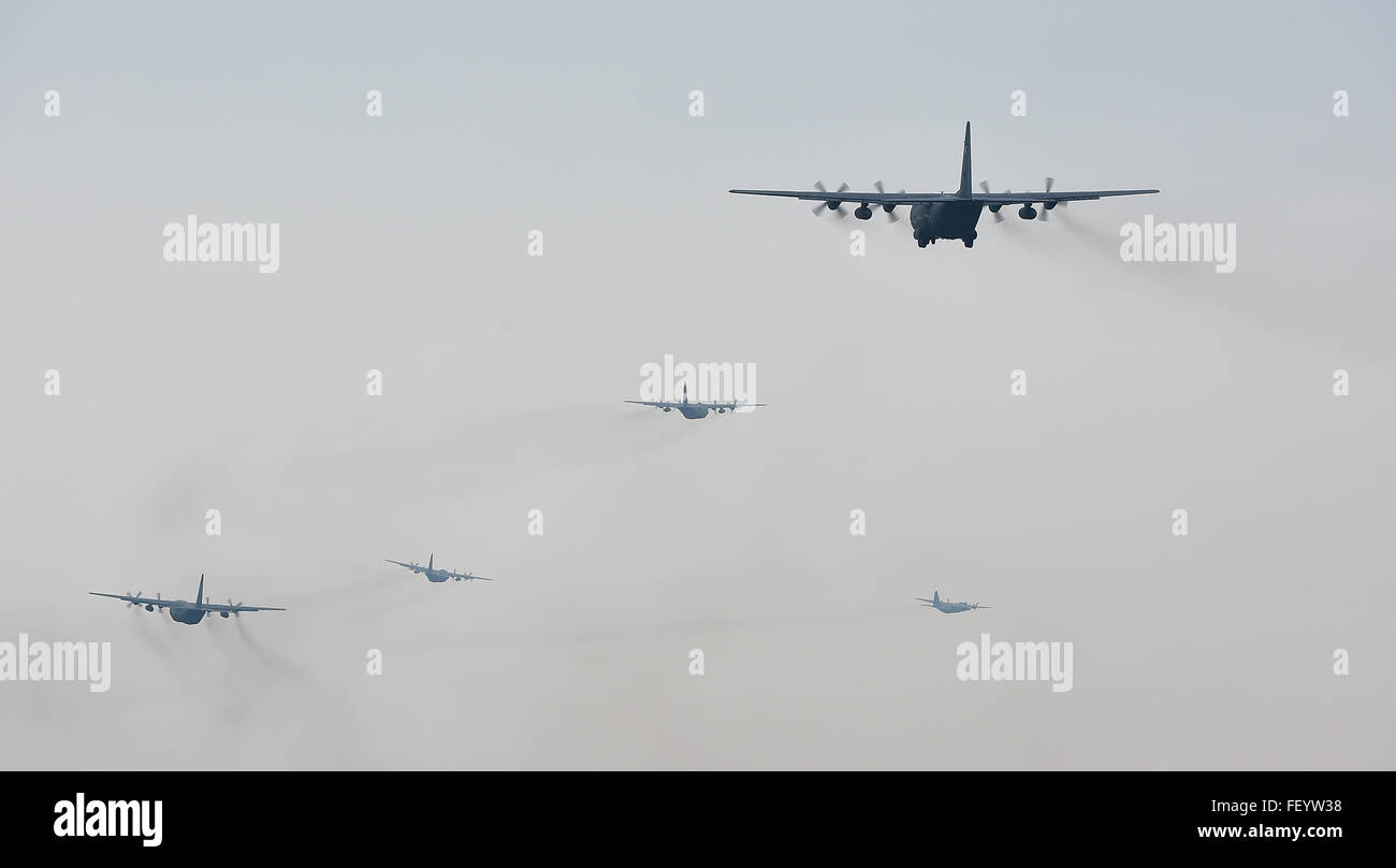 U.S. and Polish C-130s fly in formation prior to participating in a friendly airlift competition during Aviation Detachment 16-1, Oct. 29, 2015, at Powidz Air Base, Poland. A total of seven aircraft few together, marking the largest C-130 formation at Powdiz. Stock Photo