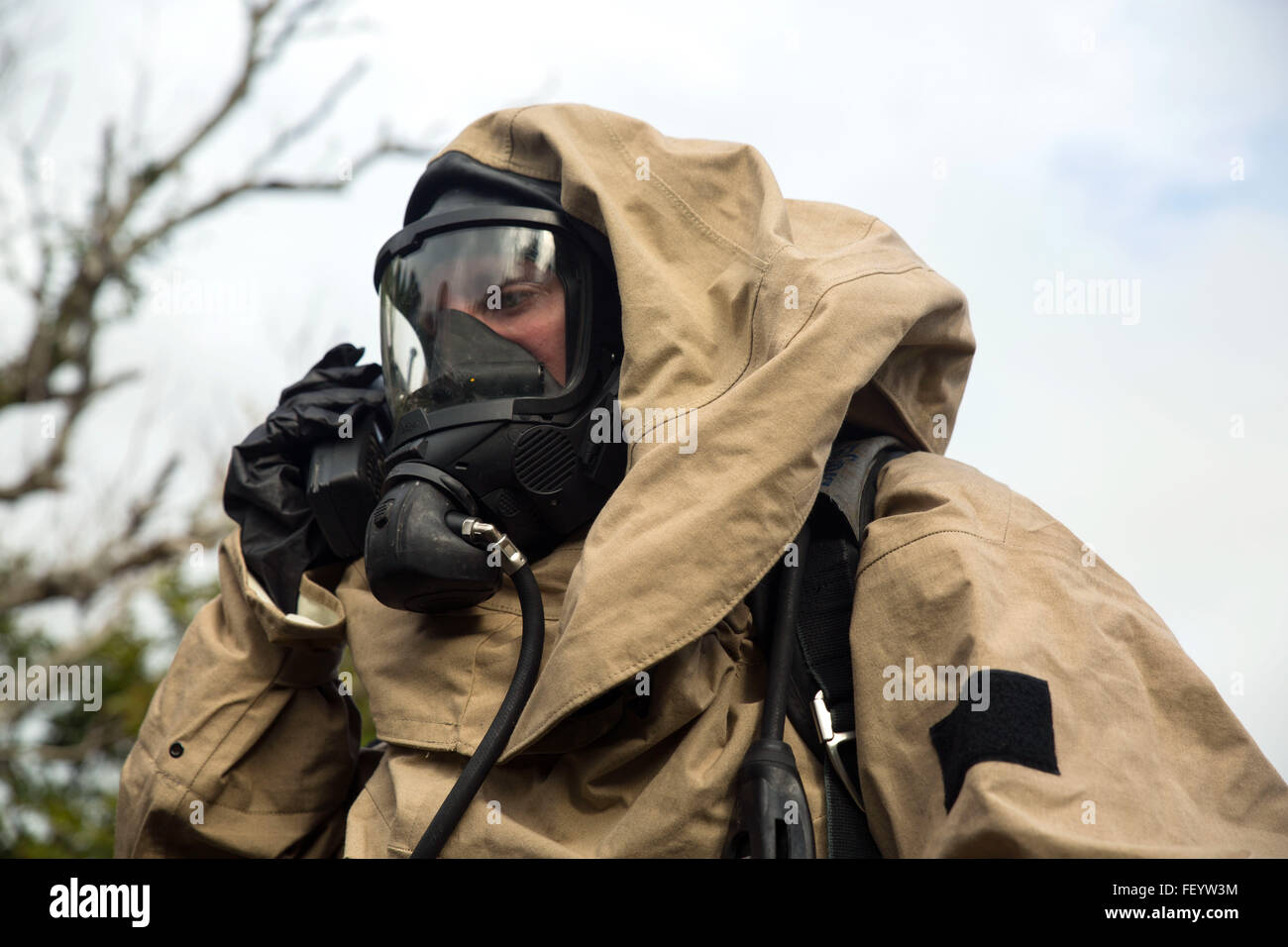 Lance Cpl. Ryan Yancey, from Emory, Texas, radios his team during a joint-training-exercise between III Marine Expeditionary Forces Chemical, Biological, Radiological, Nuclear units and Explosive Ordnance Disposal units at the Central Training Area, Camp Hansen, Okinawa, Japan, Jan. 29, 2016. The exercise enhances unit cohesion between the two units for further training, real-world instances and to keep the Asia-Pacific region safe from explosive ordnances and CBRN threats. Yancey is a CBRN defense specialist with 1st Marine Aircraft Wing, III MEF. Stock Photo