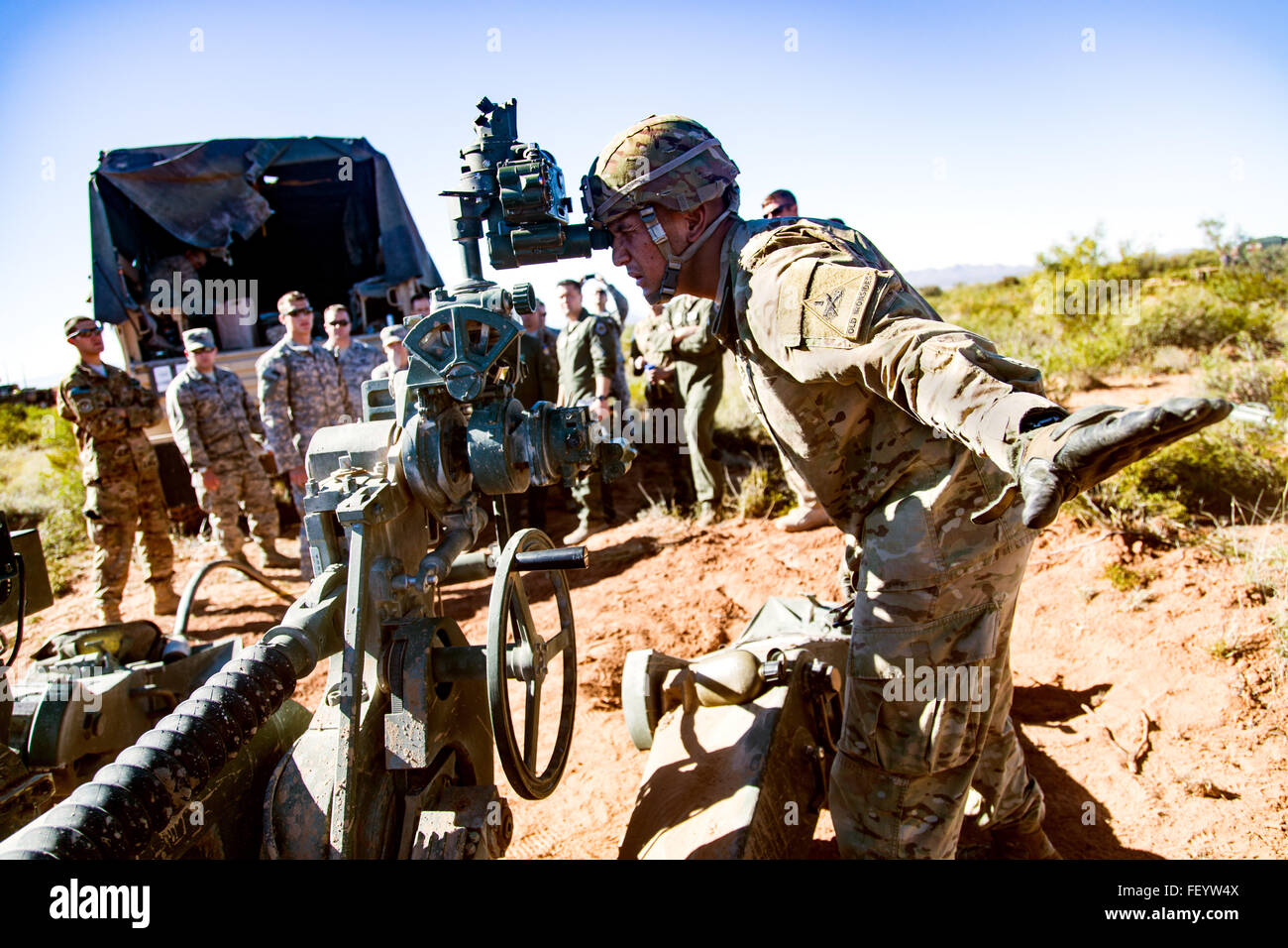 Artillerymen, Battery C, 2nd Battalion, 3rd Field Artillery Regiment, 1st Armored Division Artillery demonstrate the capabilities of M777 howitzers to pilots of the 66th Weapons Squadron, United States Air Force Weapons School during Hustler Trough II at Fort Bliss, Texas, Nov. 2. Stock Photo