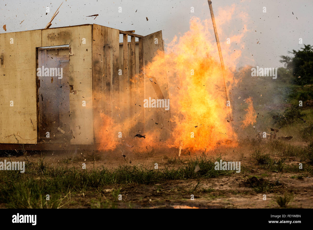 A Uganda People’s Defense Force soldier detonates an ‘oval charge’ on desired entry point while the team seeks cover around the corner of the building. This type of charge is used to create a hole through a wall when there is no available entrance or for the element of surprise. The Marines and UPDF improved breaching capabilities as they prepare for their African Union Mission in Somalia (AMISOM). Stock Photo