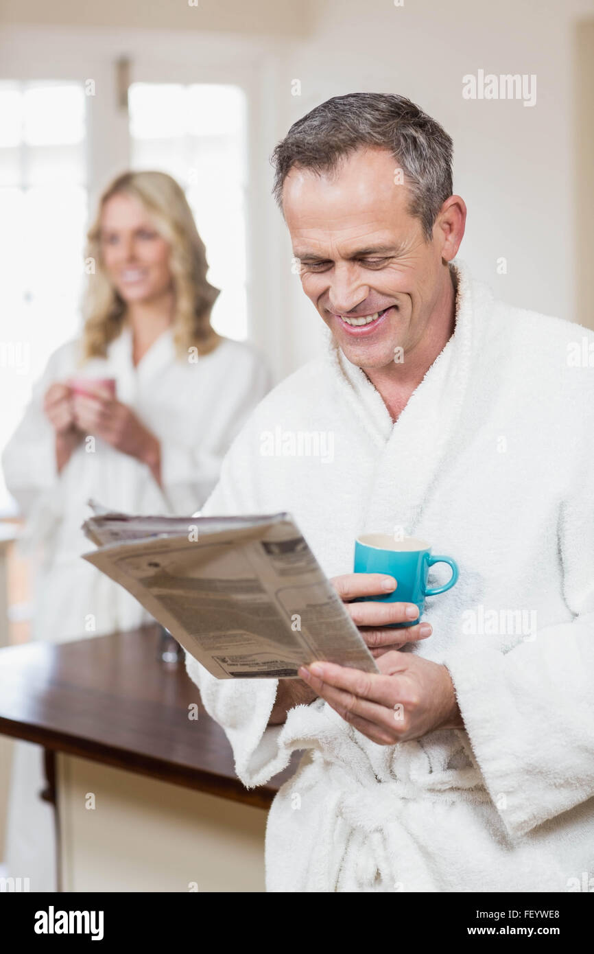 Cute couple having coffee and reading news Stock Photo