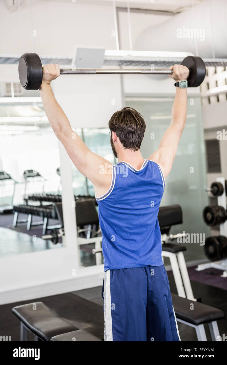 Muscular man lifting barbell Stock Photo
