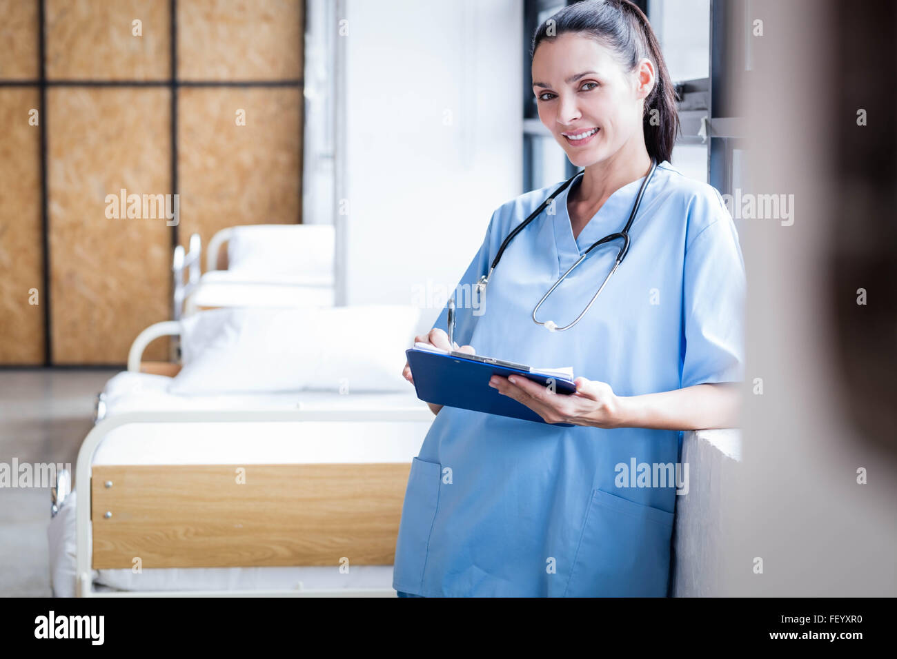 Nurse writing on a clipboard Stock Photo