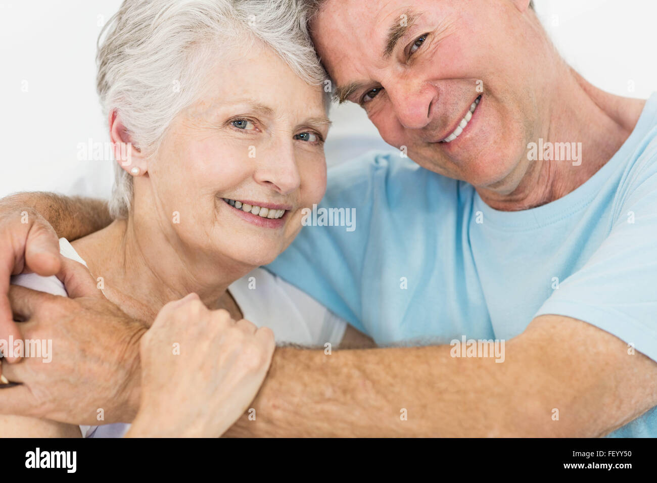 Senior couple face to face smiling at the camera Stock Photo