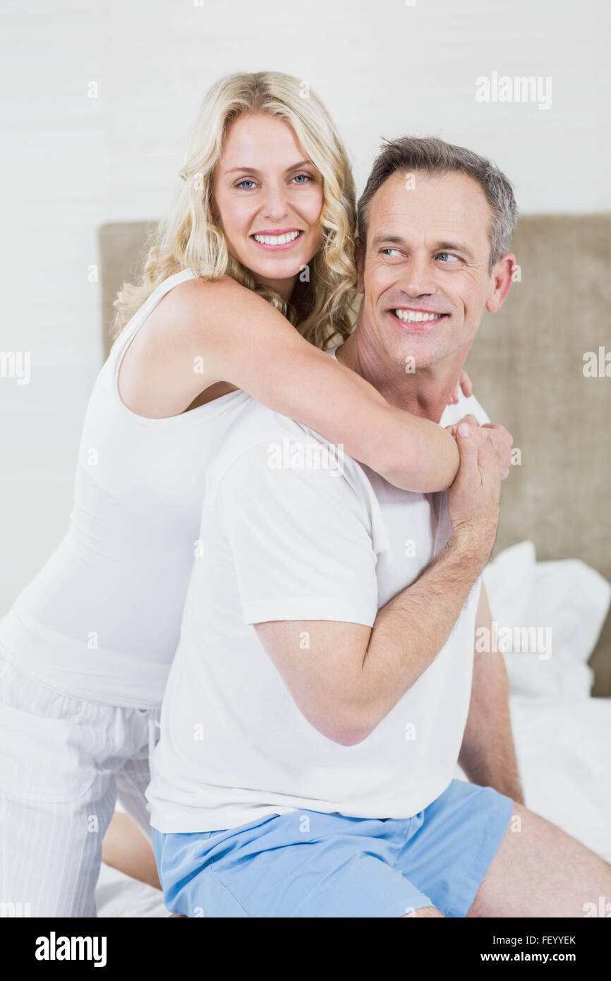 Cute couple cuddling in bed Stock Photo