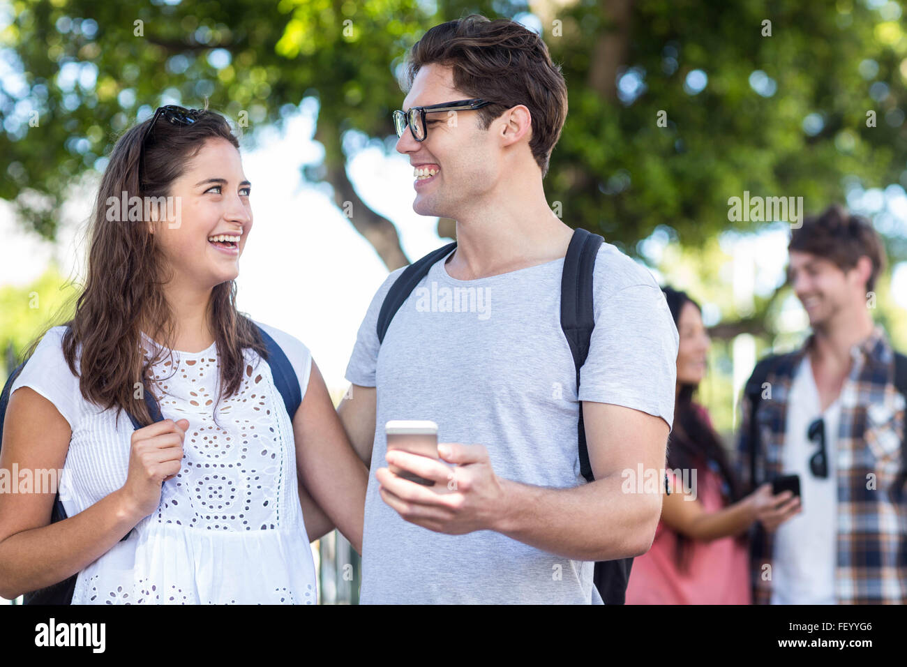 Hip couples checking at smartphone Stock Photo