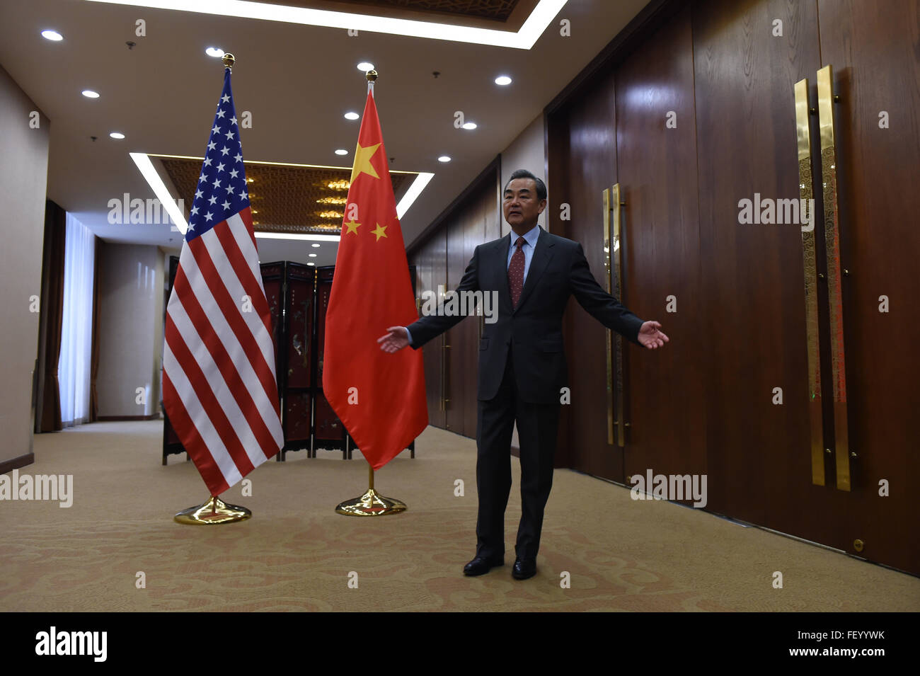 Chinese Foreign Minister Wang Yi Opens His Arms as Secretary Kerry Arrives at the Ministry of Foreign Affairs Stock Photo